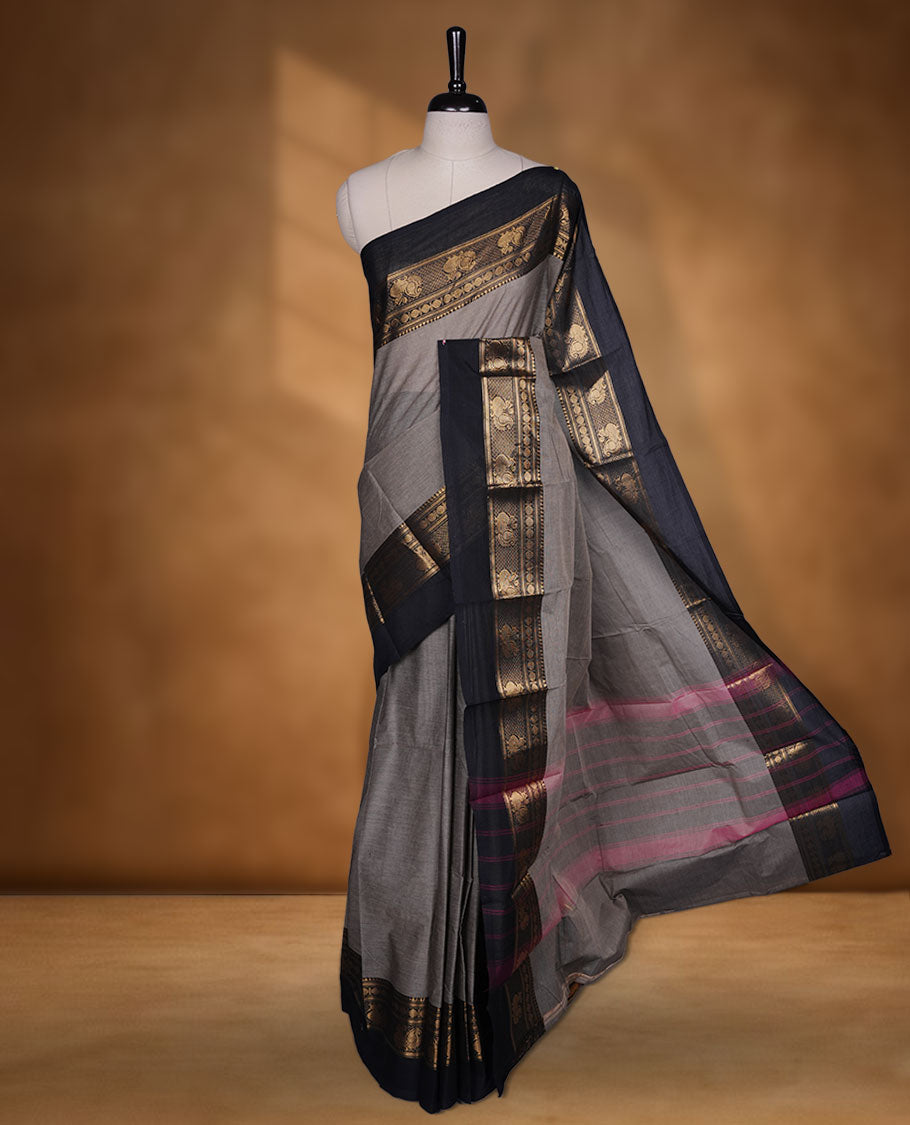 Beige grey colour chettinad cotton saree featuring plain body, contrast black colour with traditional gold zari border without blouse.