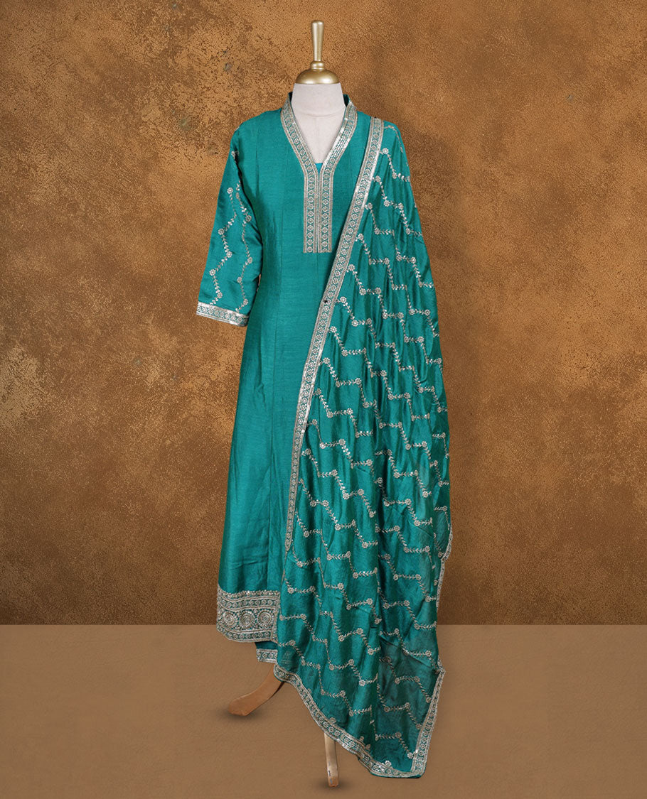 Green colour churidar set featuring thread and embroidered and beats pattern neckline, sleeves, and thread embroidery on body , Paired with a matching dupatta