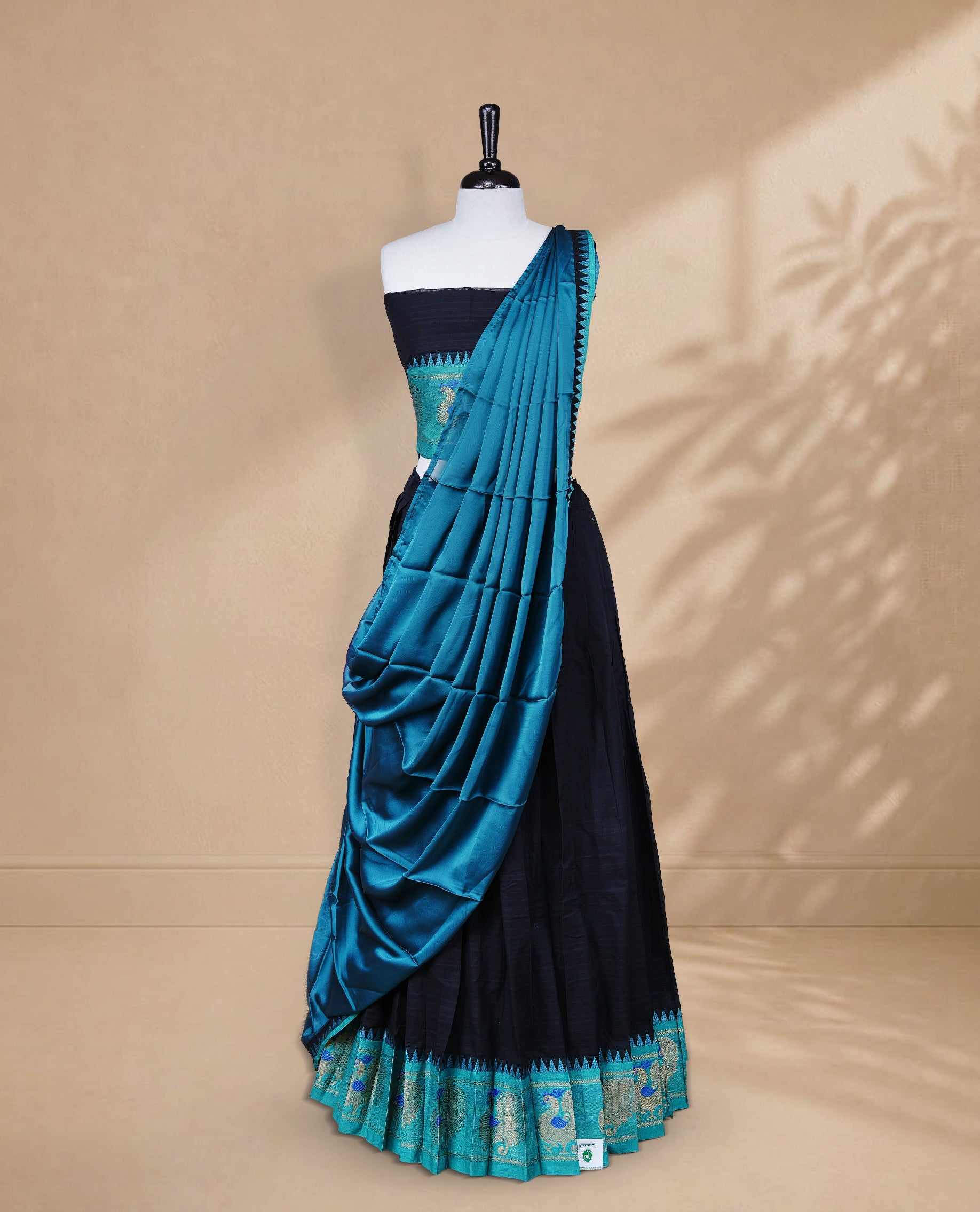 Black colour Half saree featuring Plain skirt with Zari border on contrast Aqua colour border, Unstitched Blouse and matching dupatta.