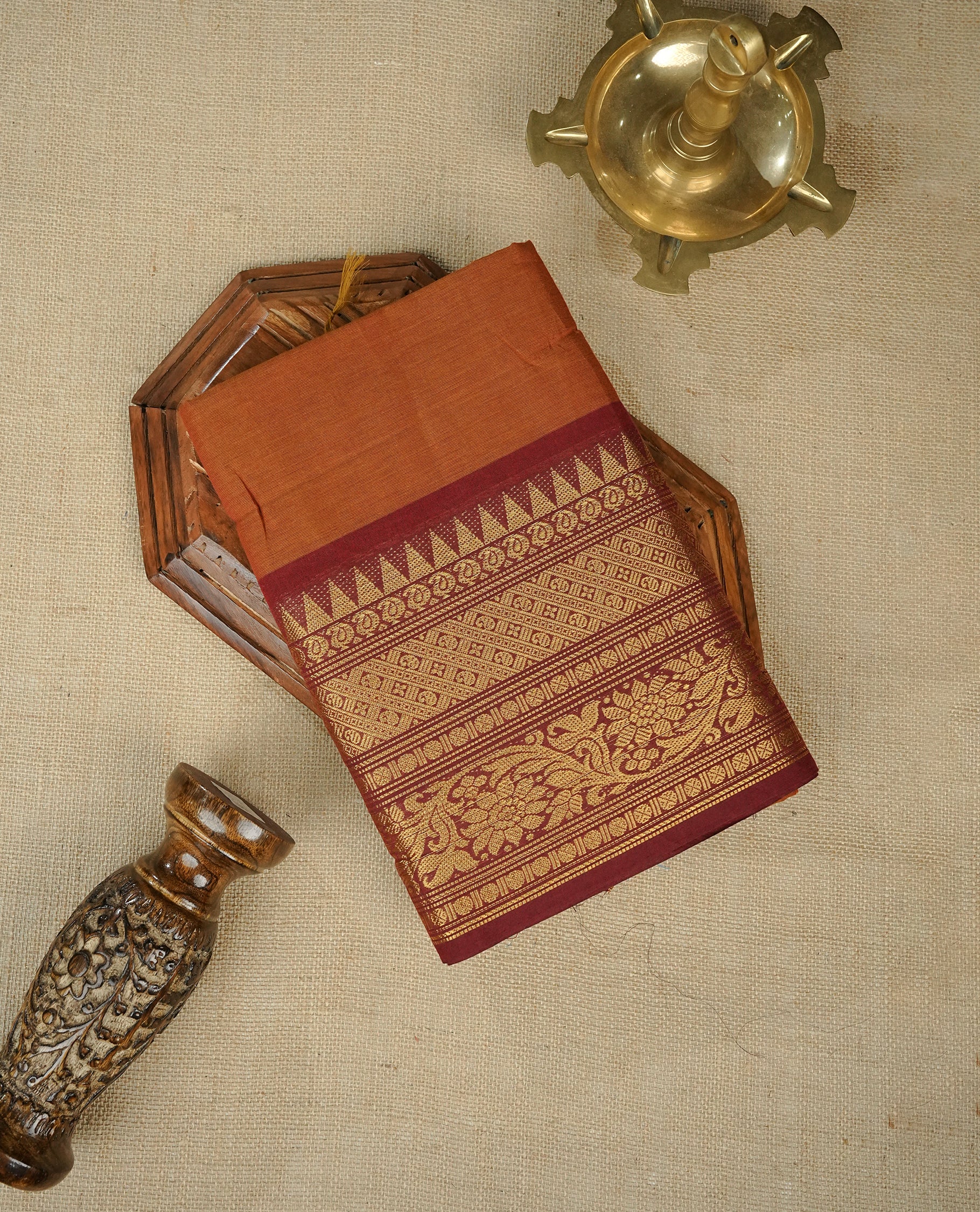 Brown colour chettinad cotton saree featuring elegant plain body, Contrast Maroon colour with Gold zari border, comes with matching blouse piece.