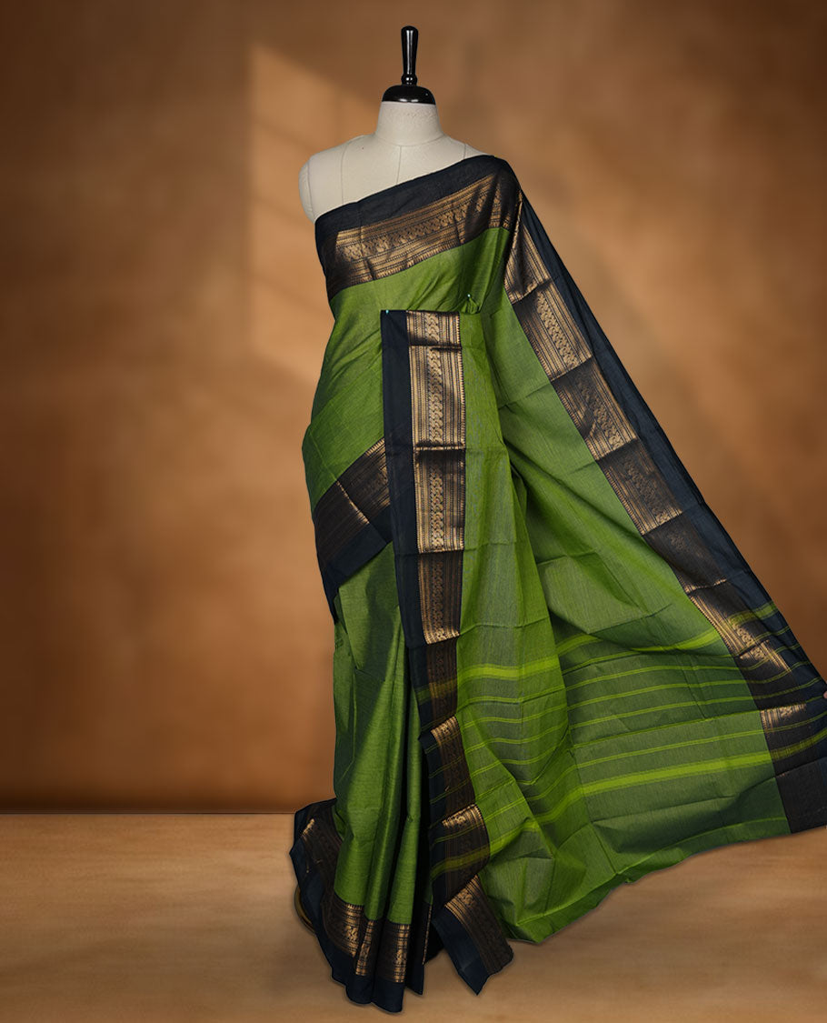 Green colour chettinad cotton saree featuring plain body, paired with a charcoal black colour traditional gold zari border without blouse.