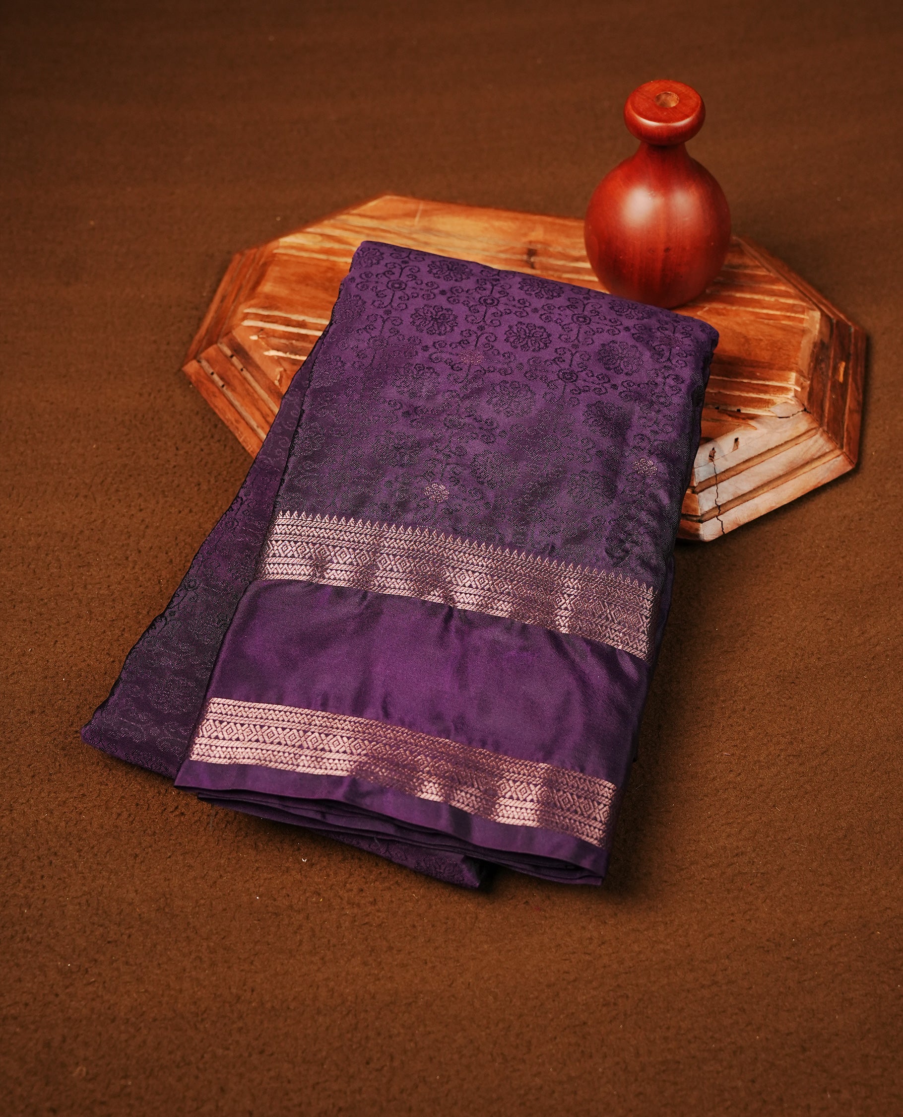Purple Colour Semi Soft Slik Saree Featuring An Elegant Self Floral Woven Body, Enhanced By A Traditional Rose Gold Zari Border And Rich Pallu, Paired With A Matching Blouse Piece.