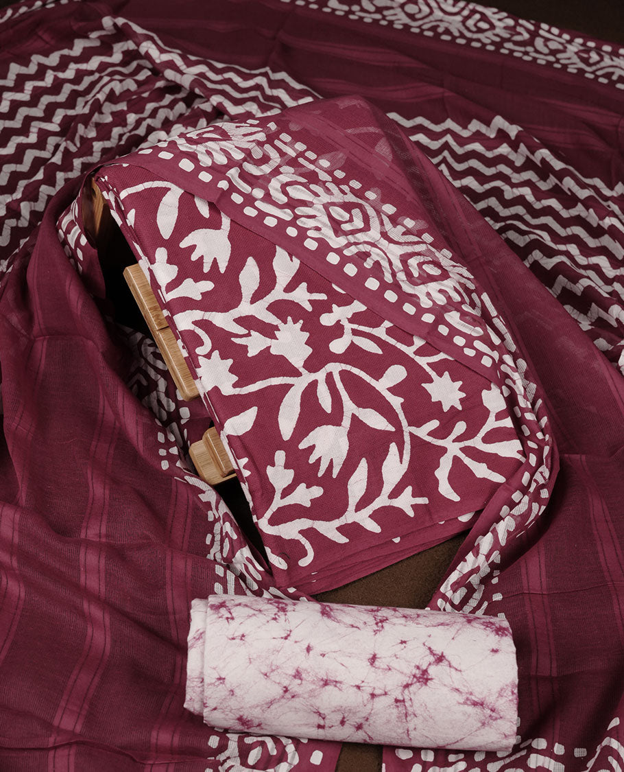 Grape wine colour churidar material featuring white floral printed body, paired with a matching chevron printed dupatta.