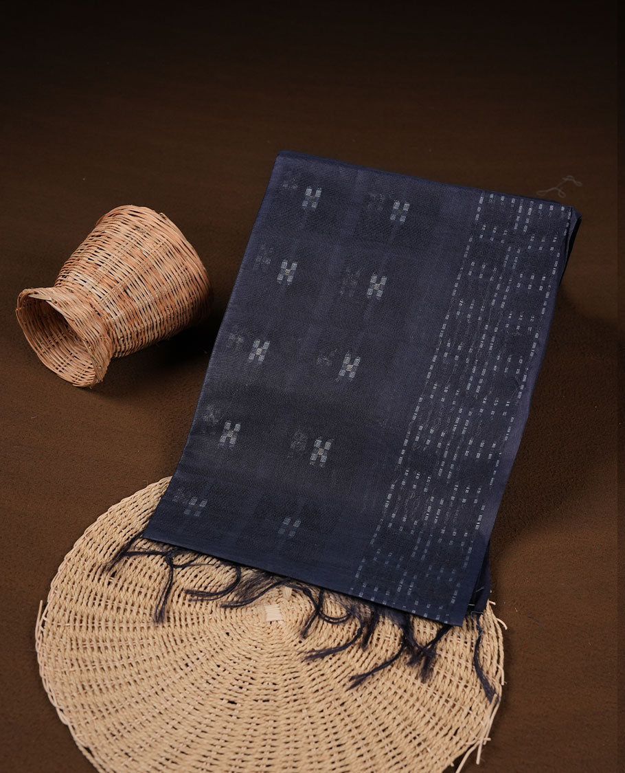 Dark blue colour semi jute saree highlighting white thread motifs on body, without border and paired with matching blouse.