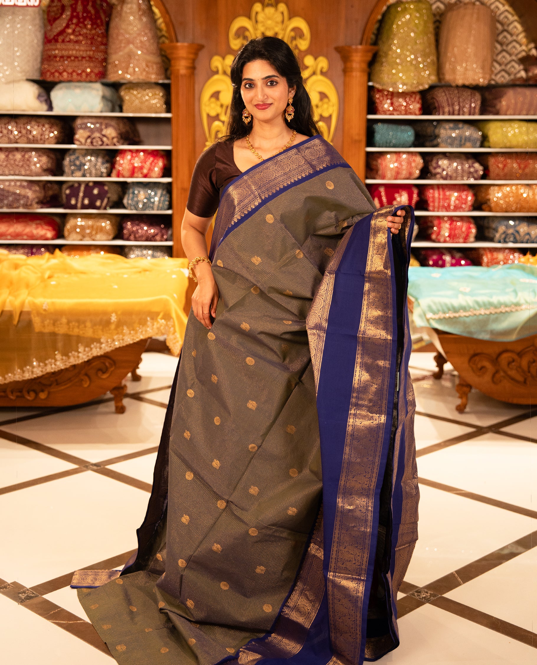 Green & Blue double shade Chettinad cotton saree featuring Gold zari strips with peacock motifs on body, complemented by contrast colour border with zari design & grand pallu, comes with matching blouse piece.