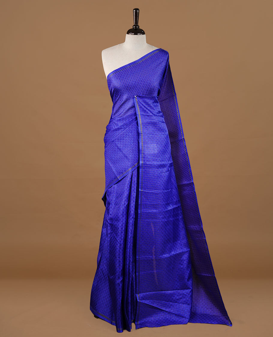 Blue colour Semi Tussar saree featuring an elegant zari fancy check pattern on the body, highlighted with a small border for a refined look. Comes without a blouse piece.