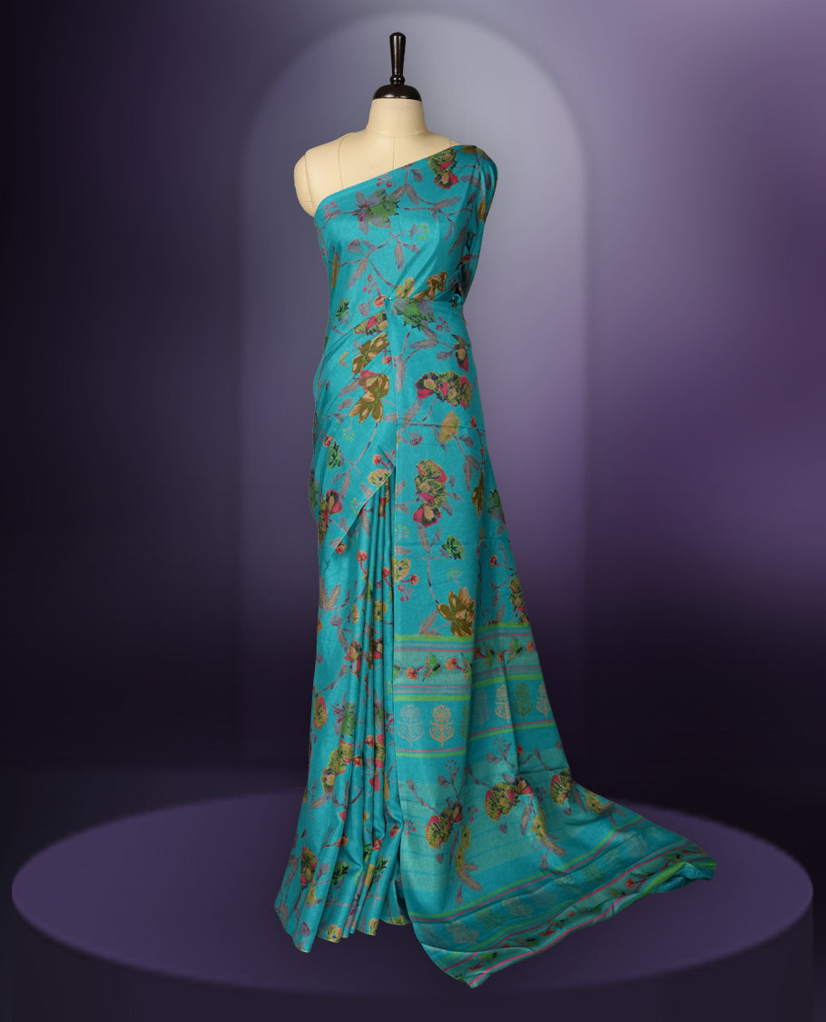 Turquoise Blue colour saree enhanced with a vibrant olive green,maroon and grey colour floral prints on body & pallu, and comes with a matching blouse.