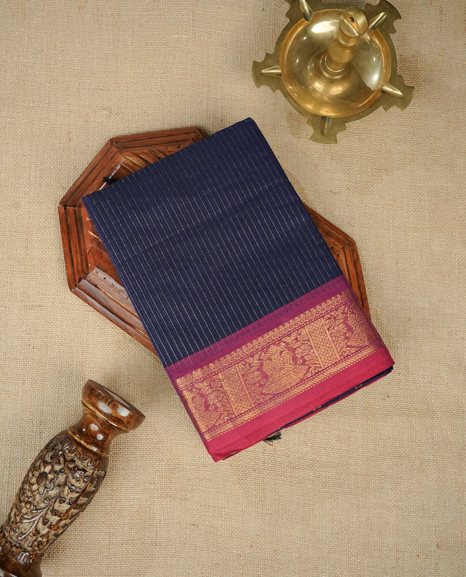 Navy blue colour chettinad cotton saree Featuring Gold zari Strips on body, complemented by contrast Magenta colour with zari border, comes with matching blouse piece.