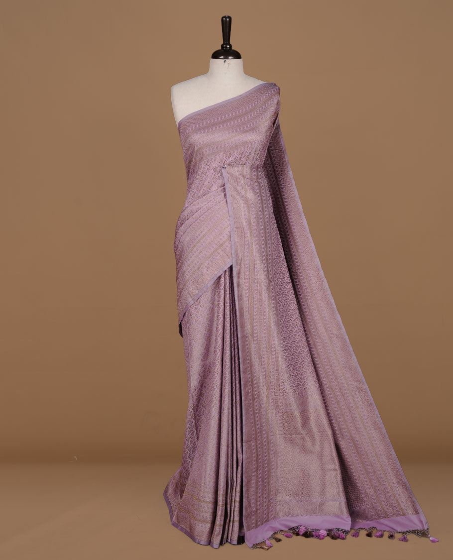 Lavender colour Semi Banaras Katan saree featuring Antique zari Floral pattern on body, complemented by self colour zari border, paired with matching blouse piece.