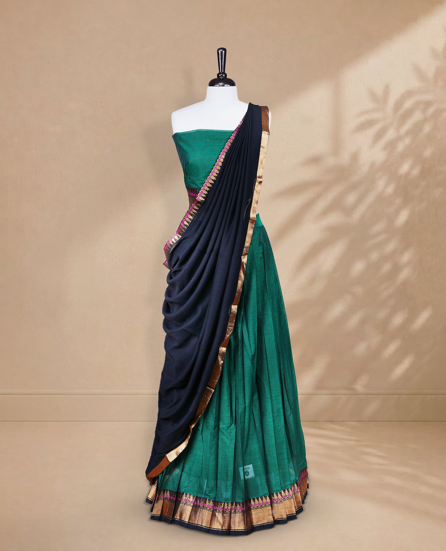 Green colour Half saree featuring Plain skirt with Zari border on contrast black colour border, Unstitched Blouse and matching dupatta.