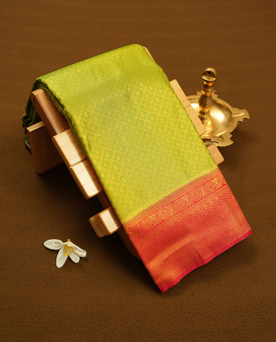 Lemon colour semi silk brocade saree featuring intricate Gold Floral Square kodi patterns across the body, complemented by a contrast red colour woven border and pallu, paired with a matching blouse.