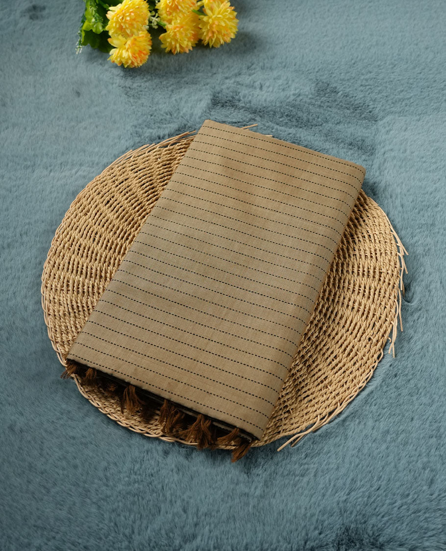 Dark Beige colour poly cotton saree with black vertical dotted line pattern on the body, paired with a matching pallu featuring black zigzag geometric border, and a coordinated all‑over black stylised fleur‑de‑lis printed blouse piece.