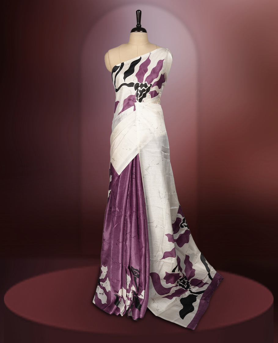 Onion pink and off white saree featuring striking black floral prints across the body, offering a chic and elegant appeal & Soft, lightweight fabric ensures graceful drapes, paired with a matching blouse.