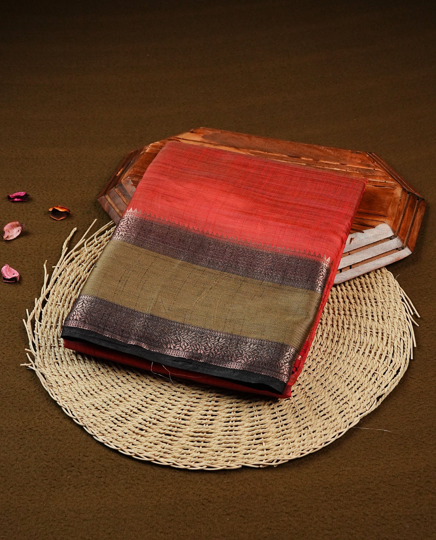 Red Tussar saree featuring Gold zari buttas on body, complemented by contrast Black & olive Colour with Gold zari border, comes with matching blouse piece.