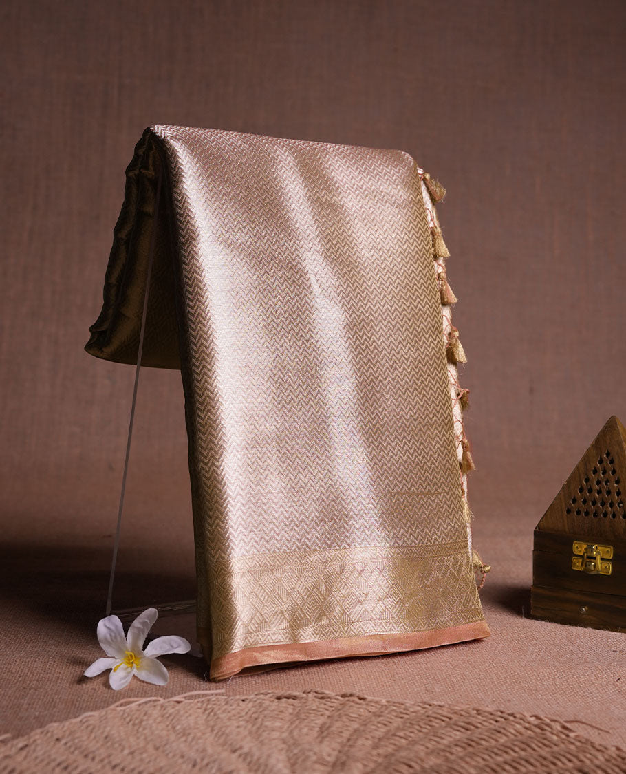 Dark Gold colour Pure banaras tissue silk saree featuring Silver zari brocade design across body, with contrast peach colour with gold zari brocade border, finished with a matching blouse.