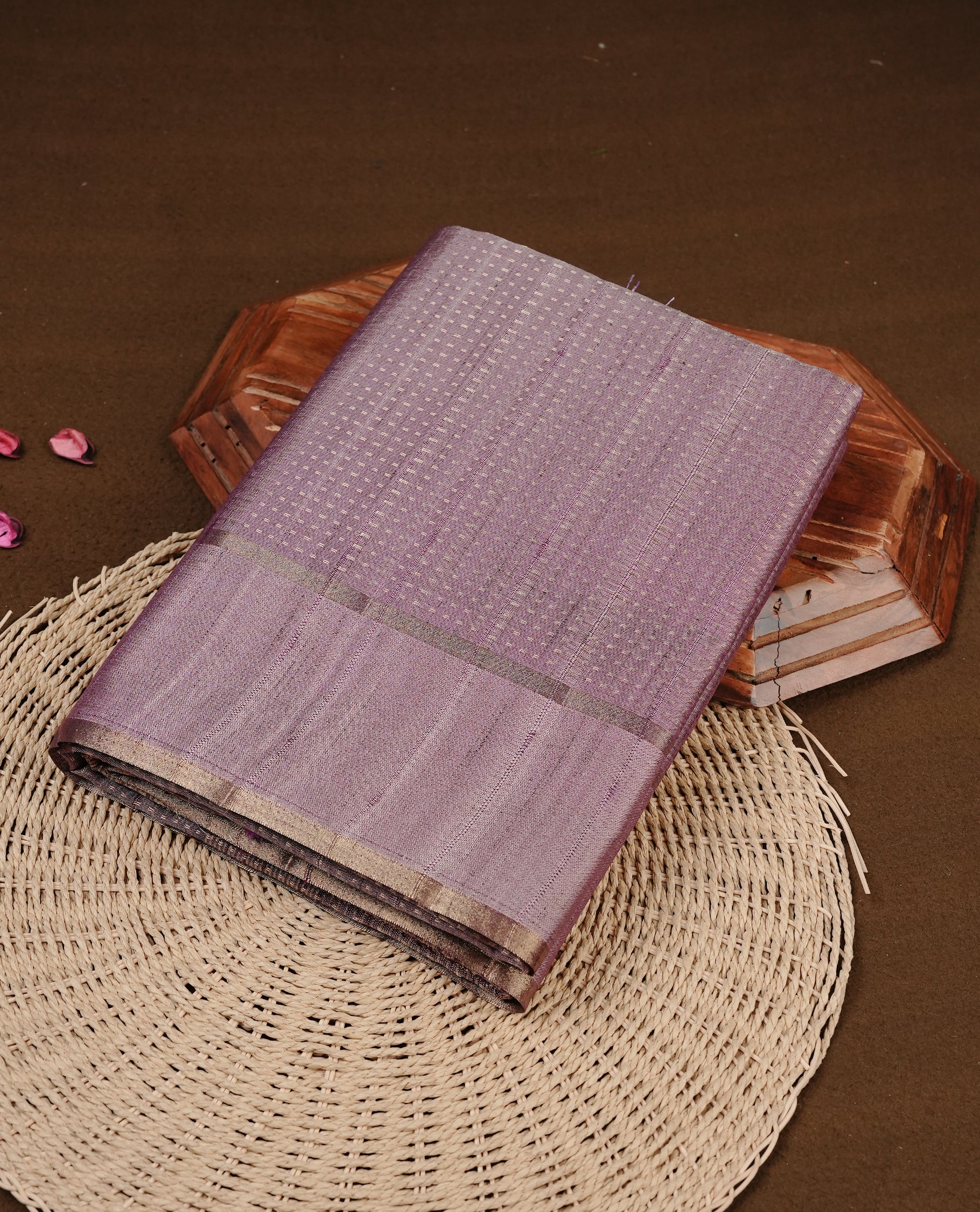 Lavender colour semi tussar silk saree featuring elegant gold zari dotted stripes across the body, enhanced with a rich zari woven border. Comes with a matching blouse piece.