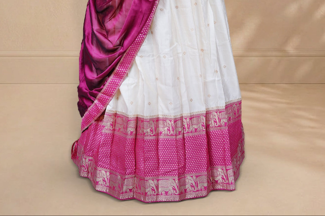 Cream colour Half saree featuring Gold zari buttas on skirt with Zari border on contrast Magenta colour border, Unstitched Blouse and matching dupatta.