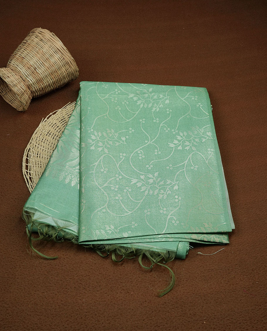 Green colour semi tussar silk saree, featuring an intricate gold zari floral kodi pattern on the body and pallu, comes with matching blouse.