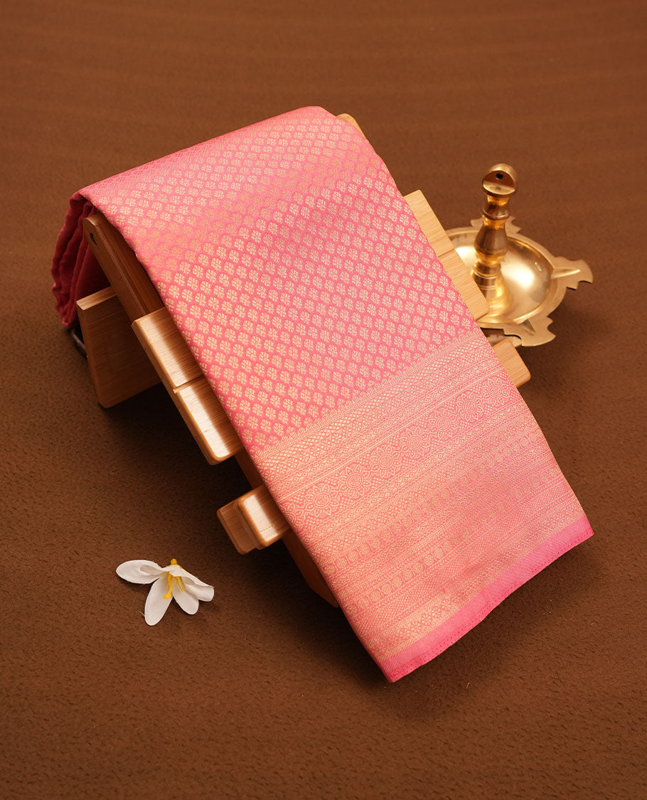Pink colour semi silk brocade saree featuring intricate Gold patterns across the body, complemented by a Self colour woven border and pallu, paired with a matching blouse.