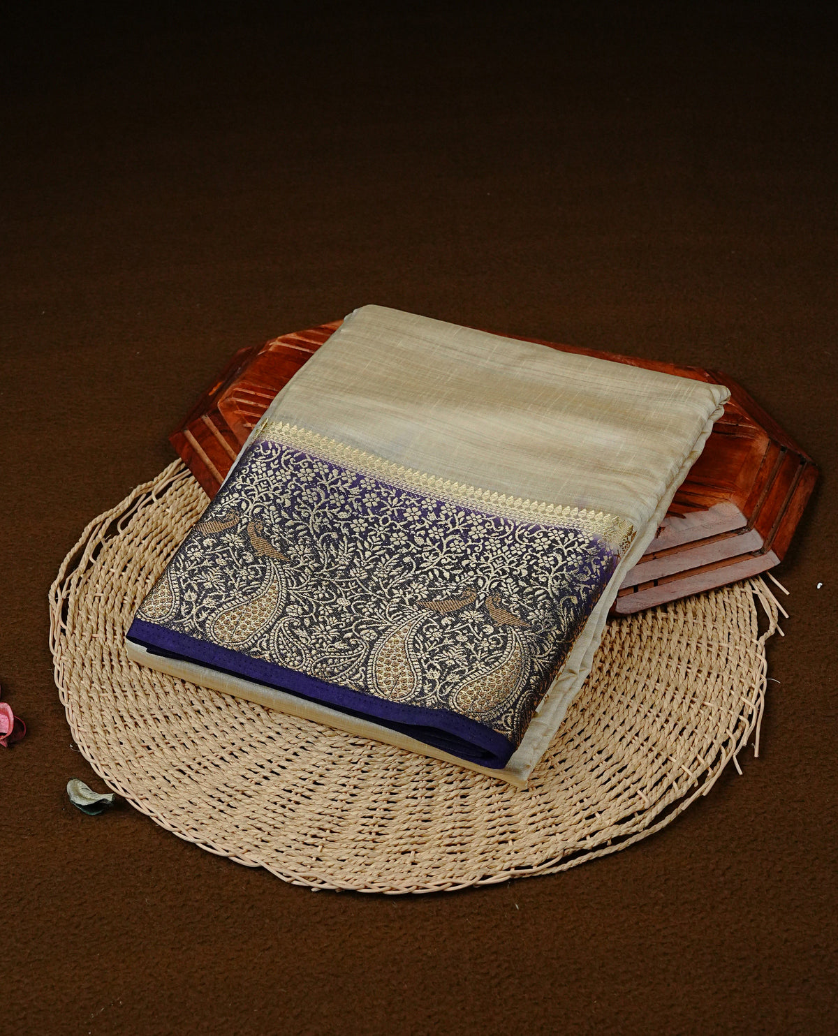 Light gold tussar saree featuring Elegant plain body, complemented by contrast Navy Blue colour with Gold zari Floral kodi with Peacock Pattern border, comes with matching blouse piece.