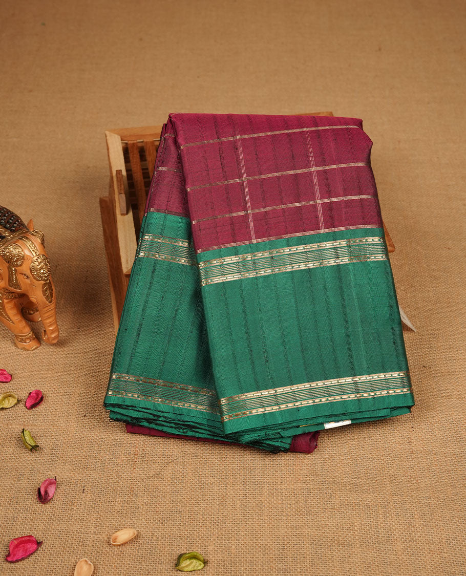 Maroon colour pure traditional Kancheepuram silk saree adorned with an elegant zari check pattern across the body, complemented by a contrast zari woven border, paired with a matching blouse piece.