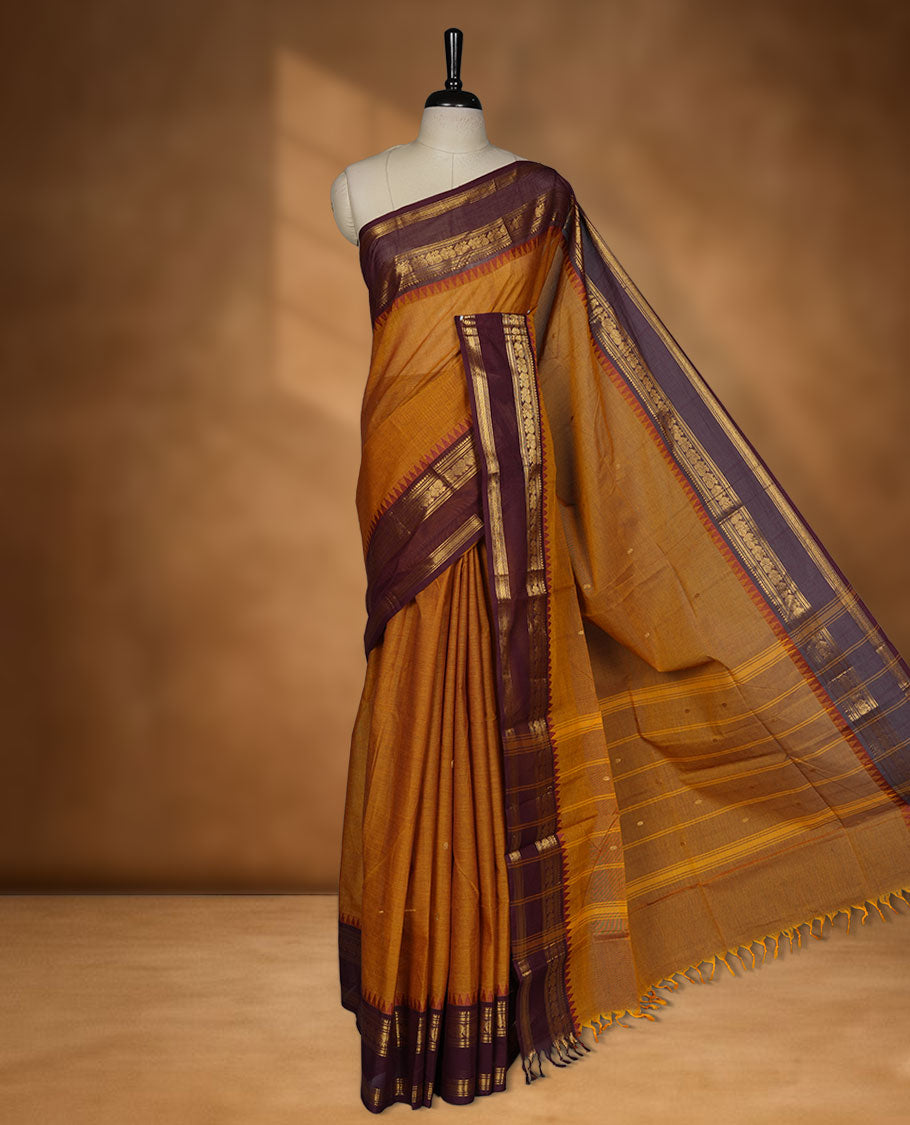 Mustard colour chettinad cotton saree featuring Purple colour motifs on body, contrast maroon colour border with gold zari temple border, pallu and paired with matching blouse