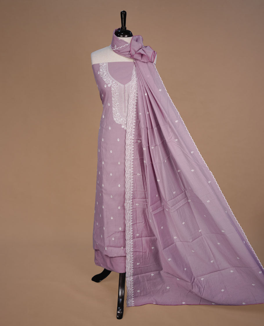 Pastel Purple colour churidar material feating white thread motifs on body and floral kodi pattern neckline, paired with matching bottom and dupatta