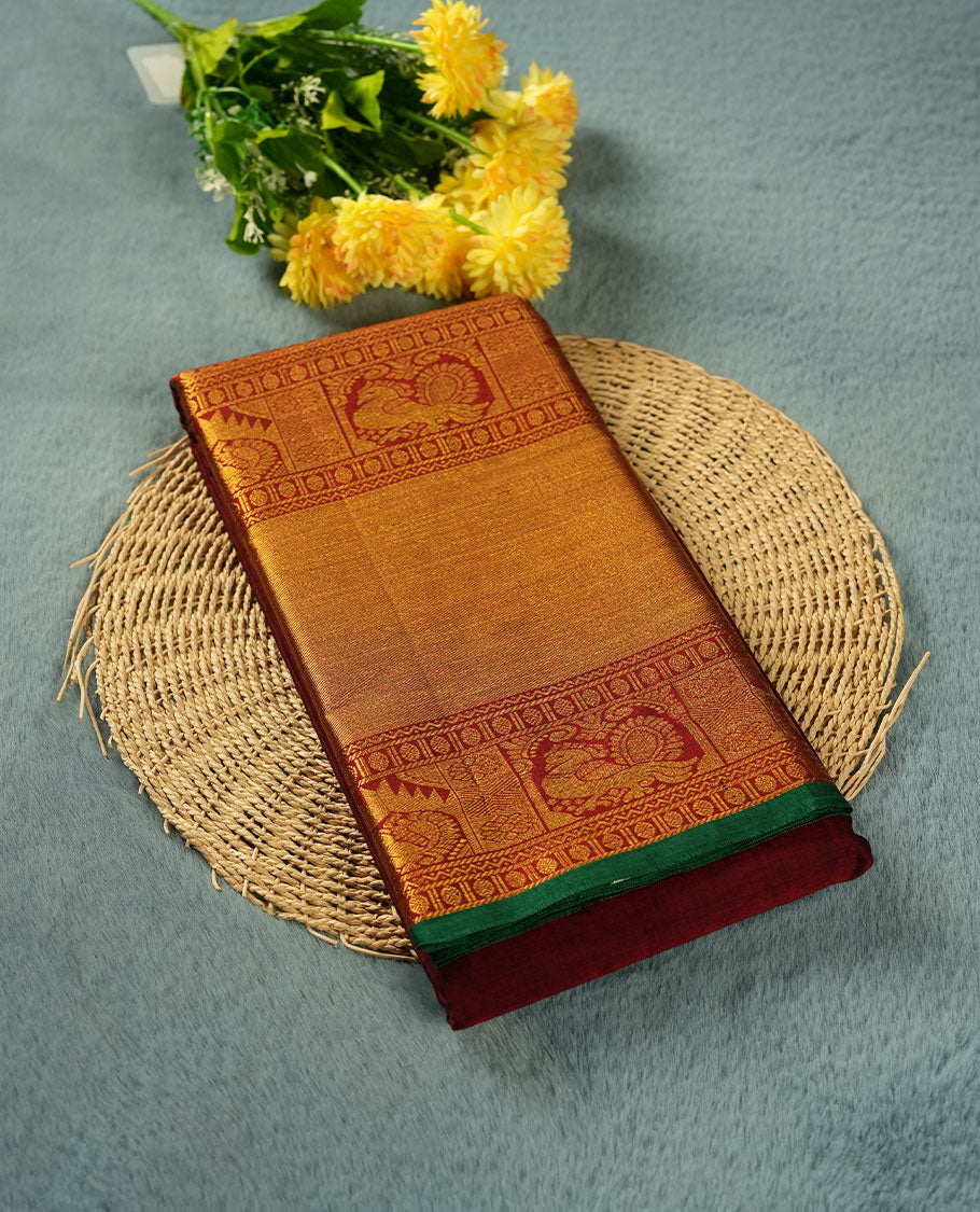 Dark red colour Narayanapattu cotton saree featuring a self coloured body, contrast Green colour with gold zari border and pallu, pairing a matching blouse piece.