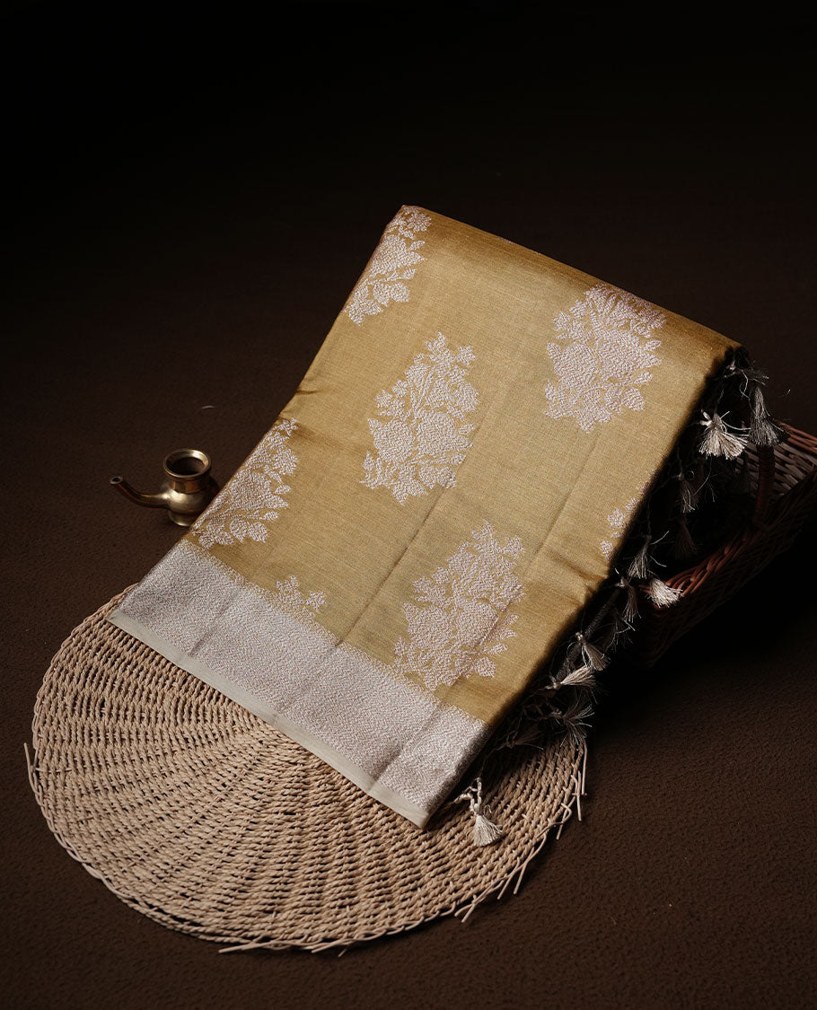 Olive colour pure banaras tusser silk saree highlighting antique zari pattern across body, with contrast cream colour with zari border and paired with matching blouse