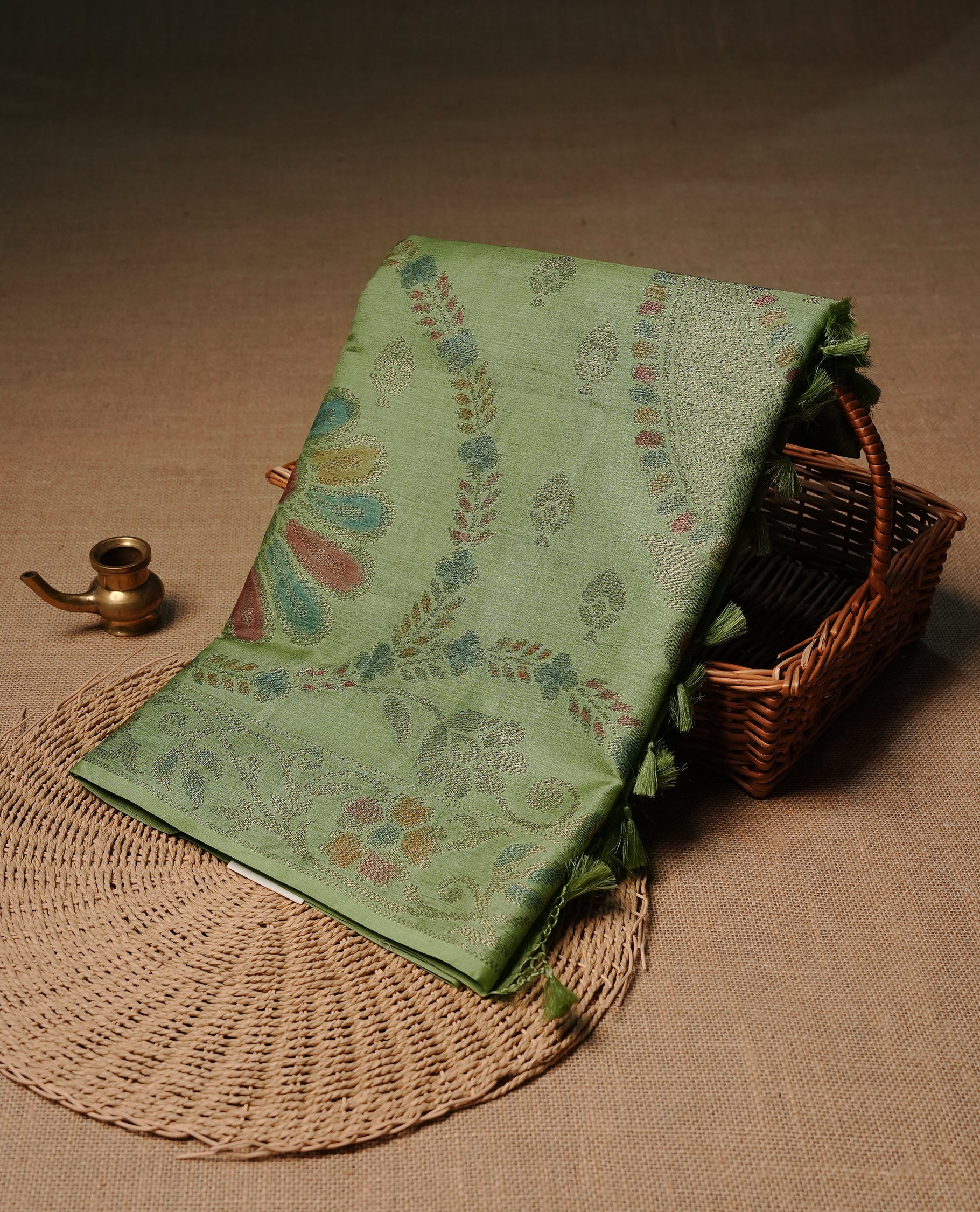 Pastel green colour pure tussar silk saree featuring elegant antique zari kodi patterns across the body, designed with a graceful borderless finish for a refined look. Paired with a matching blouse piece.