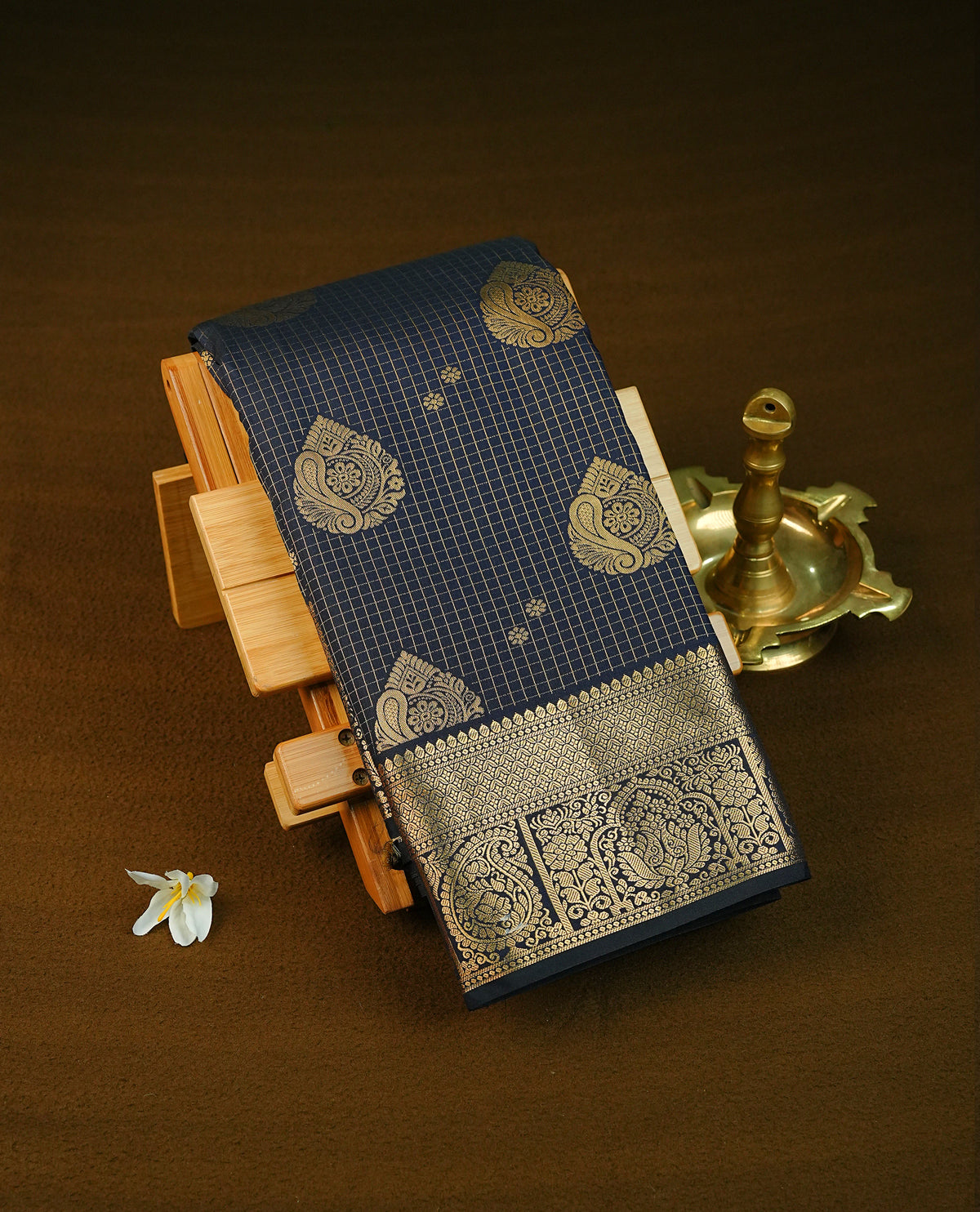 Navy blue colour semi wedding saree featuring gold zari check pattern with motifs on body, complemented by self colour With Traditional border, comes with matching blouse piece.