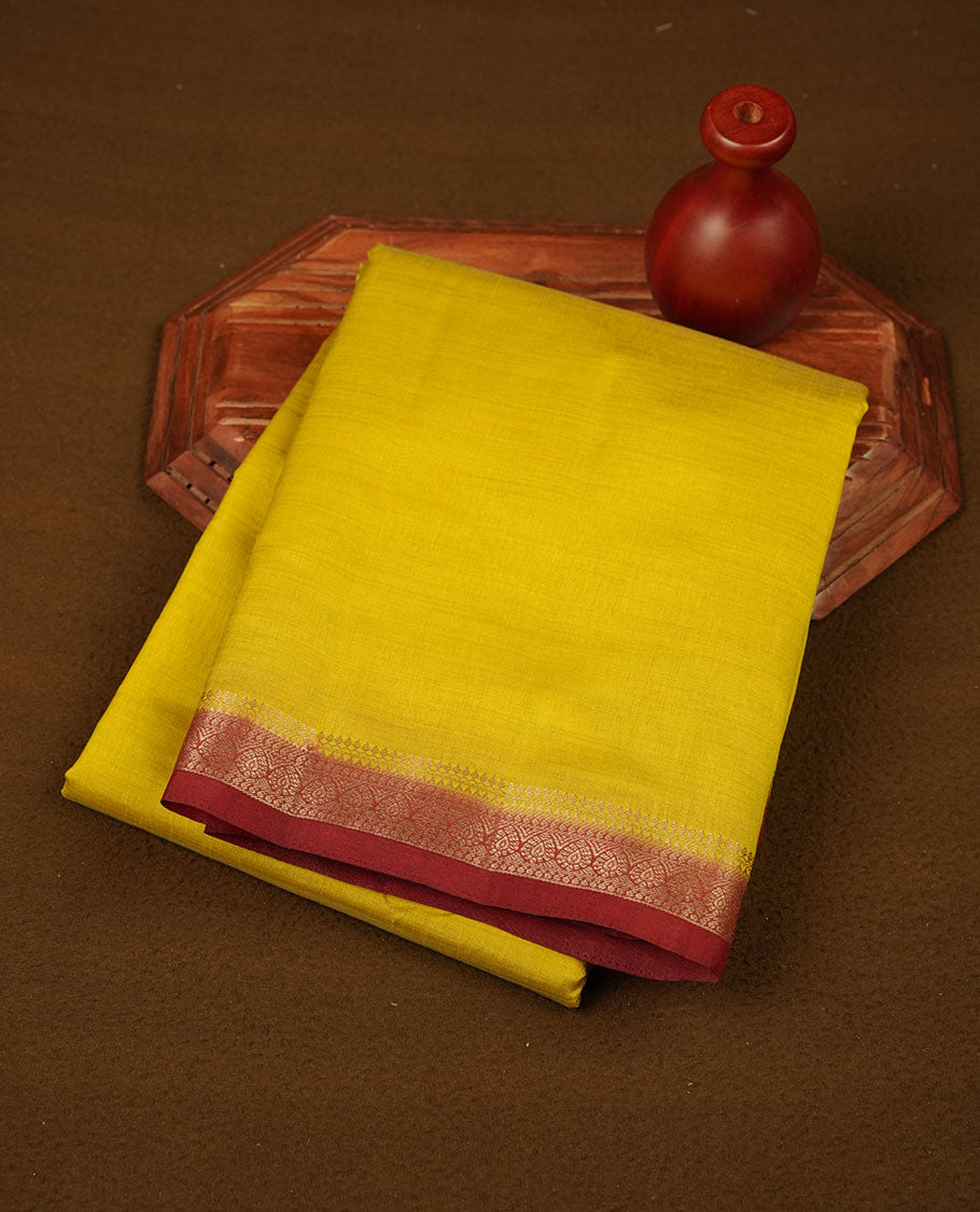 Olive colour tussar saree featuring elegant plain body, contrast Maroon colour gold zari border and comes with matching blouse piece.
