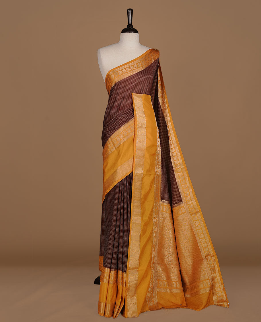 Chocolate colour semi georgette saree featuring gold zari check pattern on body, complemented by contrast Mustard colour with zari border, paired with matching blouse piece.