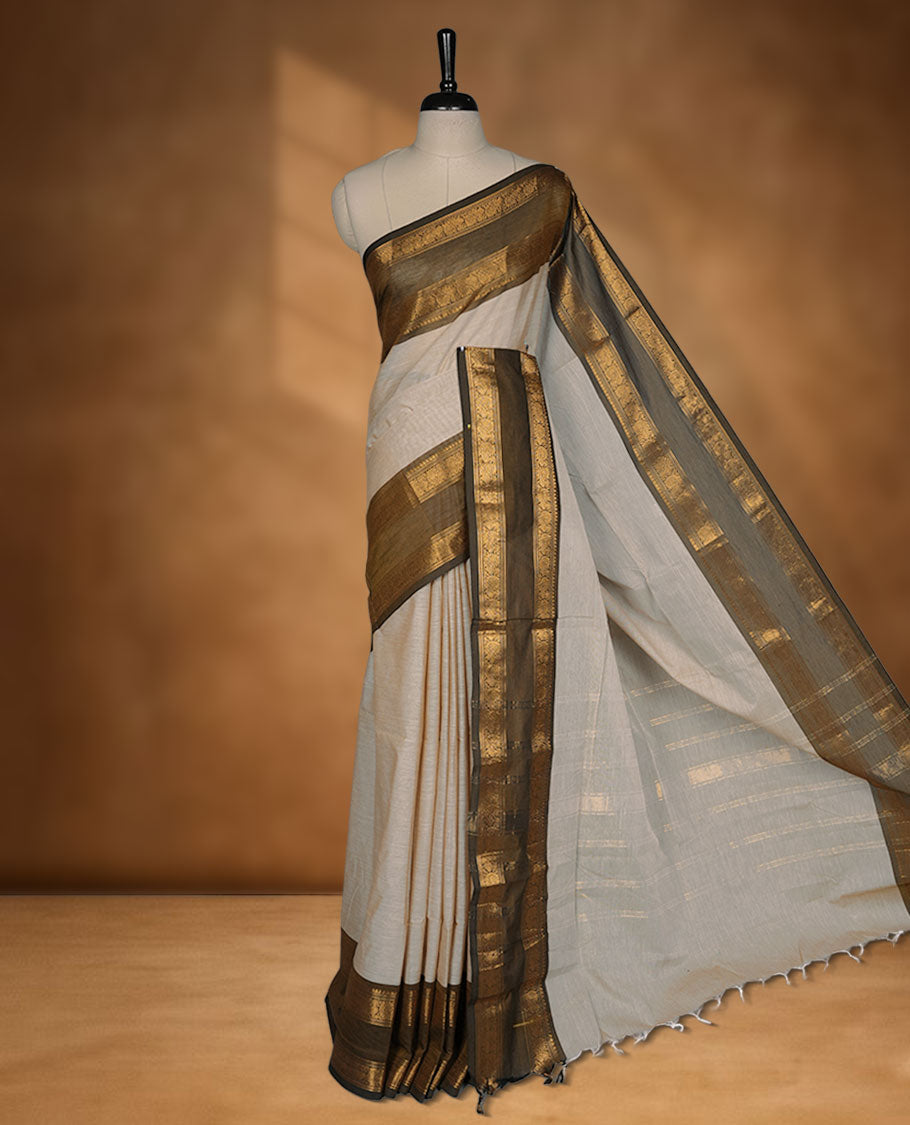 Beige colour chettinad cotton saree featuring Elegant body, contrast Olive colour border with gold zari border, pallu and paired with matching blouse.