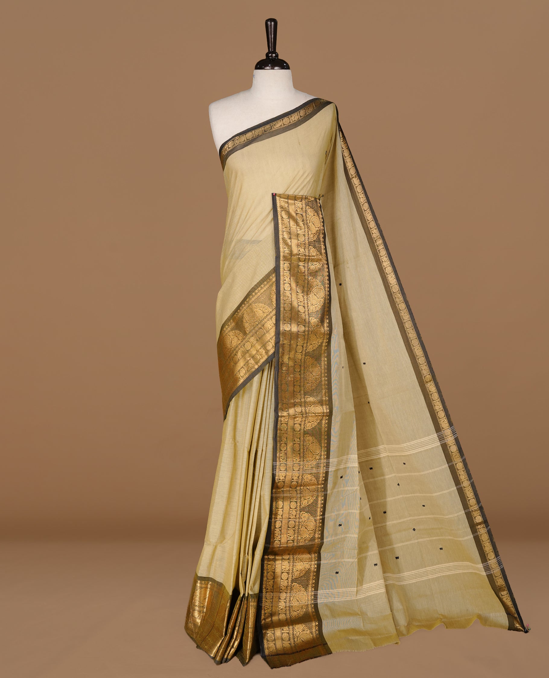 Grey beige colour Chettinad cotton saree featuring motifs on body , complemented by contrast Black colour with zari border, comes with matching blouse piece.