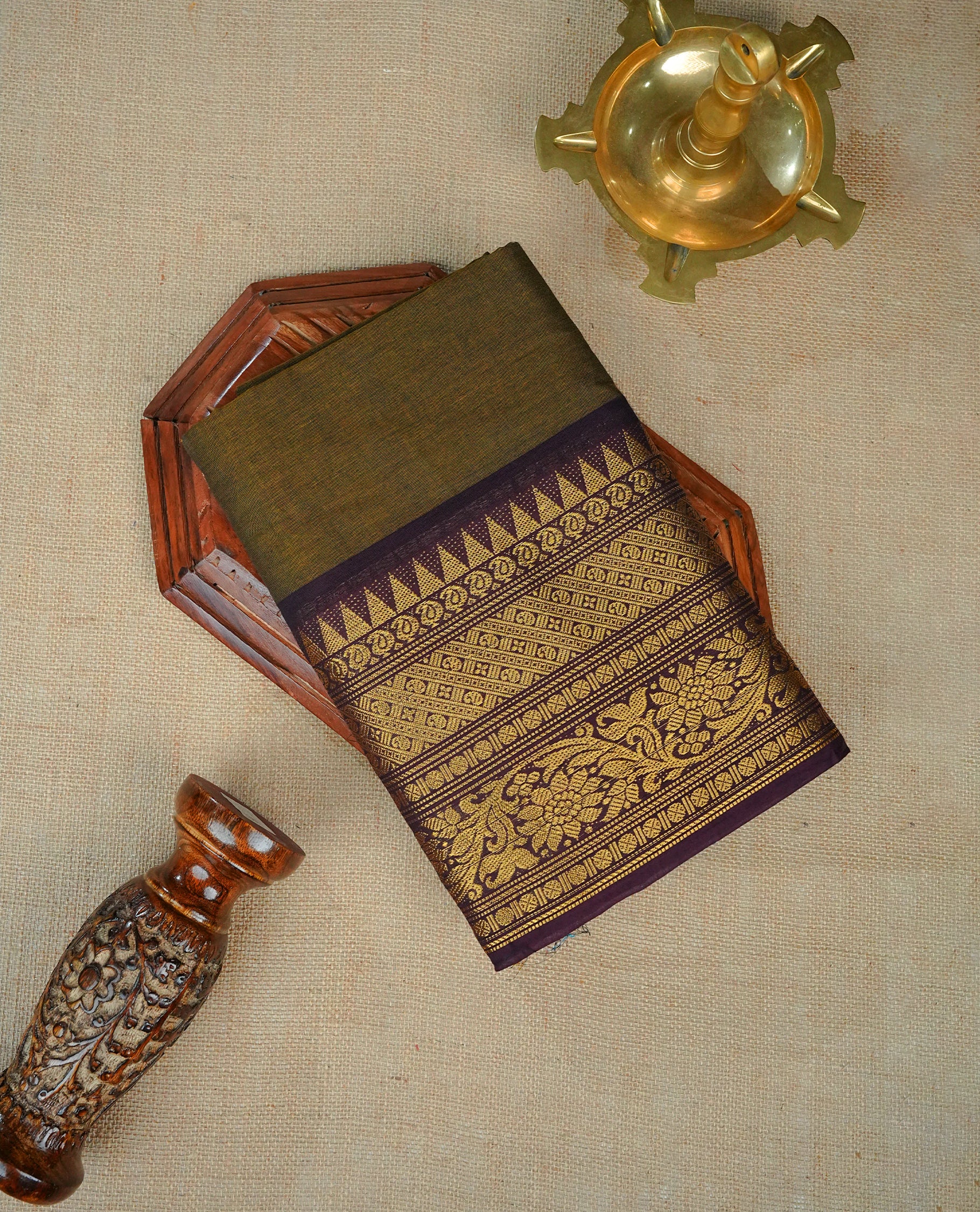 Olive colour chettinad cotton saree featuring elegant plain body, Contrast Chocolate colour with Gold zari border, comes with matching blouse piece.