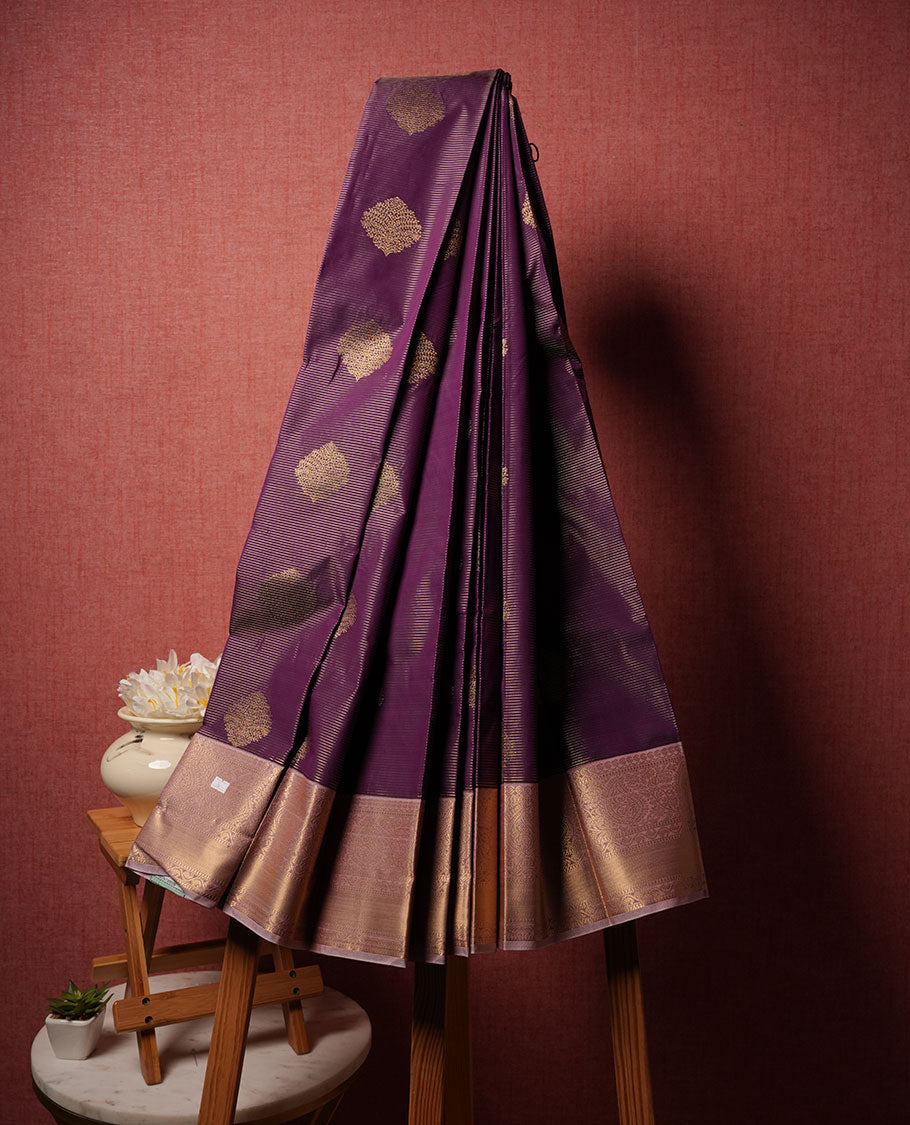 Purple colour semi silk saree highlighting gold zari strip pattern and motifs across body, featuring contrast lavender colour border with gold zari pattern, comes with matching blouse .