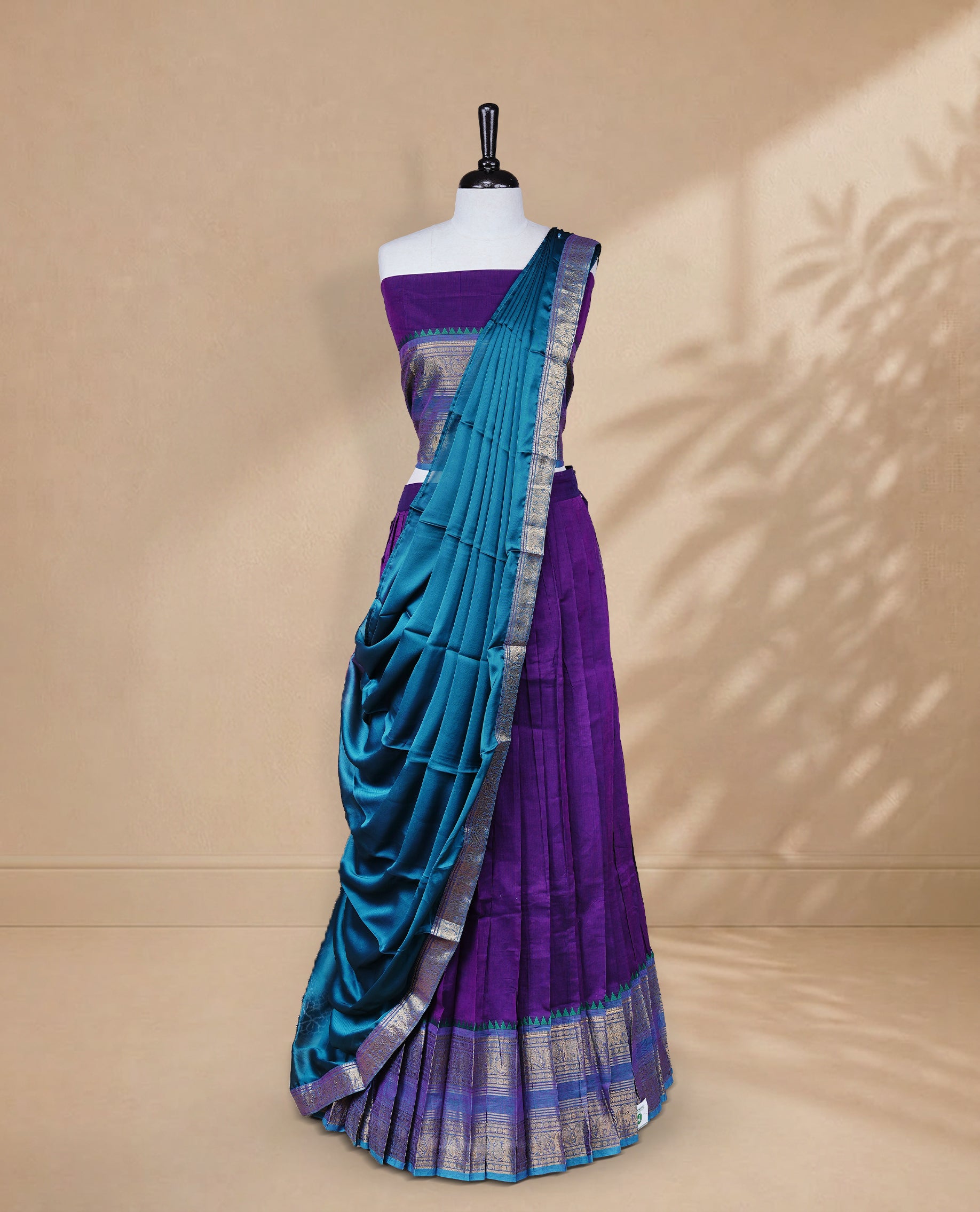 Purple colour Half saree featuring Plain skirt with Zari border on contrast Teal colour border, Unstitched Blouse and matching dupatta.