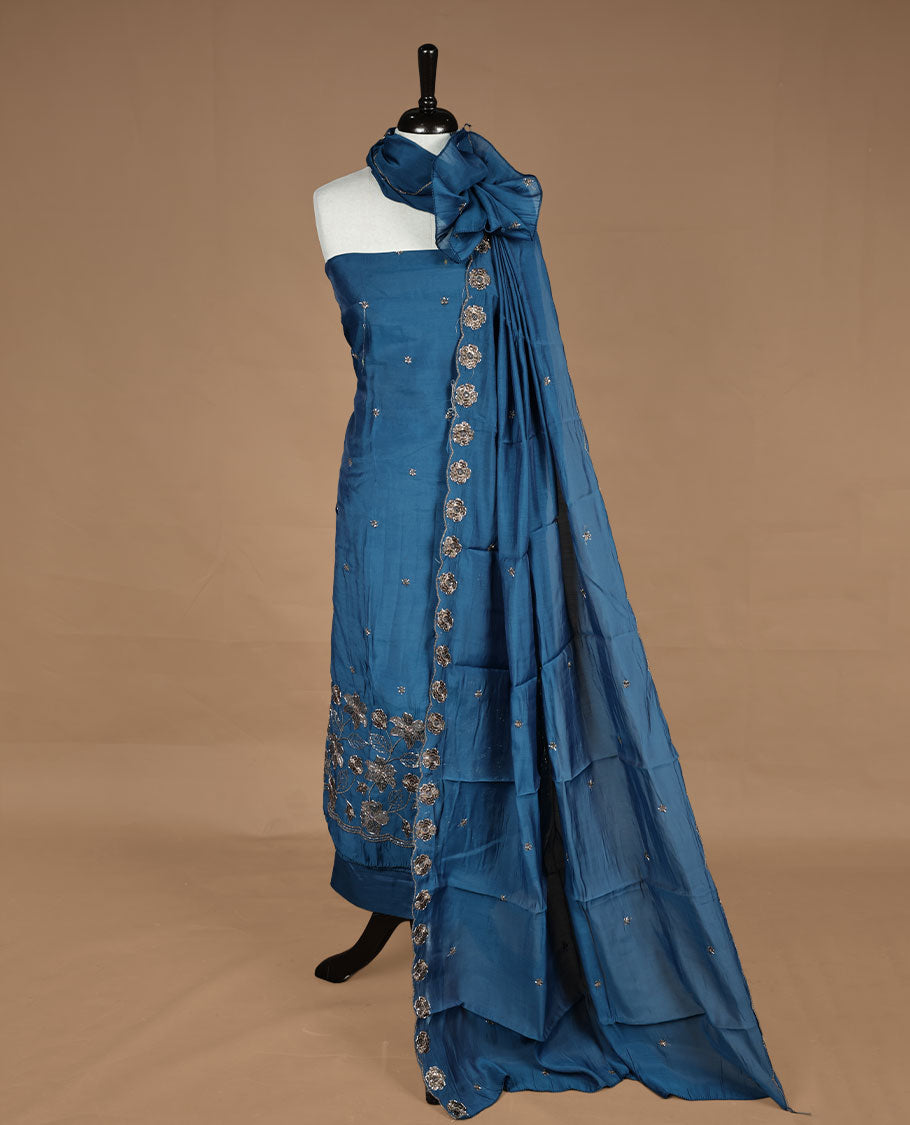Blue colour churidar materal featuring floral cut beats and thread work on body, paired with matching bottom and dupatta.