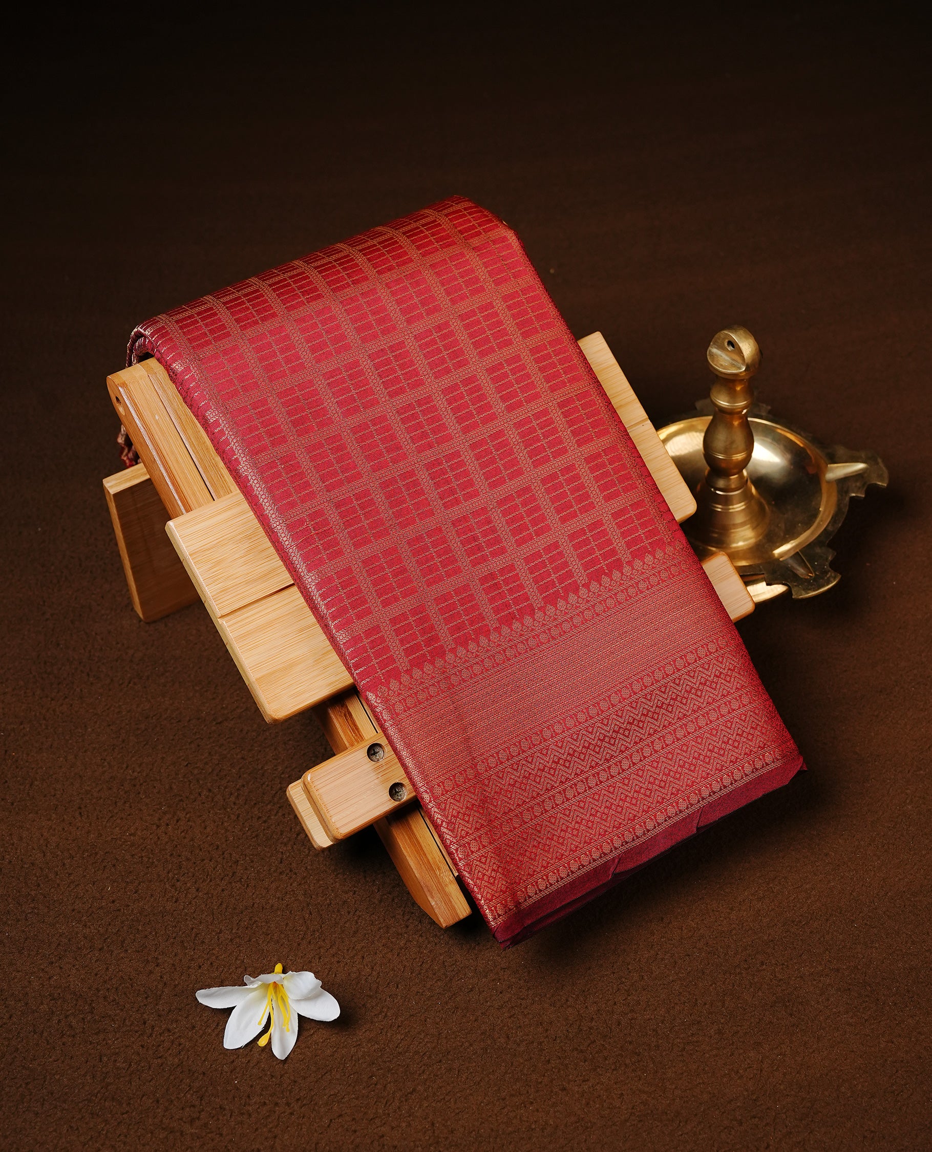 Maroon colour Semi Wedding silk saree featuring gold zari Check pattered body, complemented by self colour with traditional border, paired with matching blouse piece.