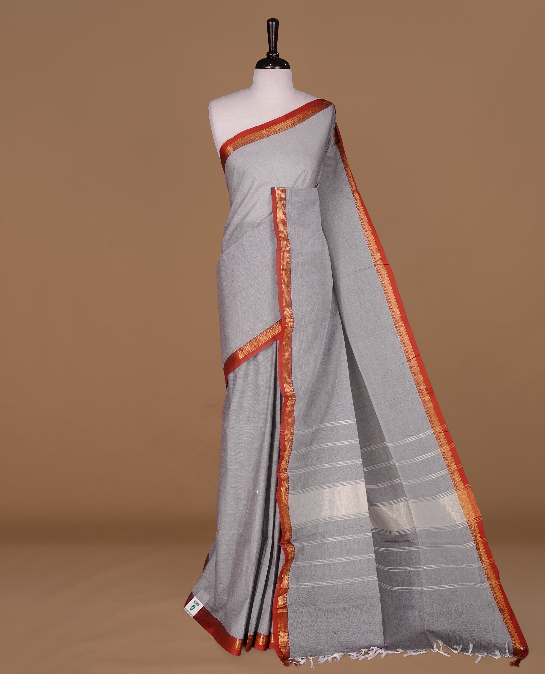 Grey Colour Chettinad cotton saree featuring elegant plain body , complemented by contrast Brown colour with simple traditional border, comes with matching blouse piece.
