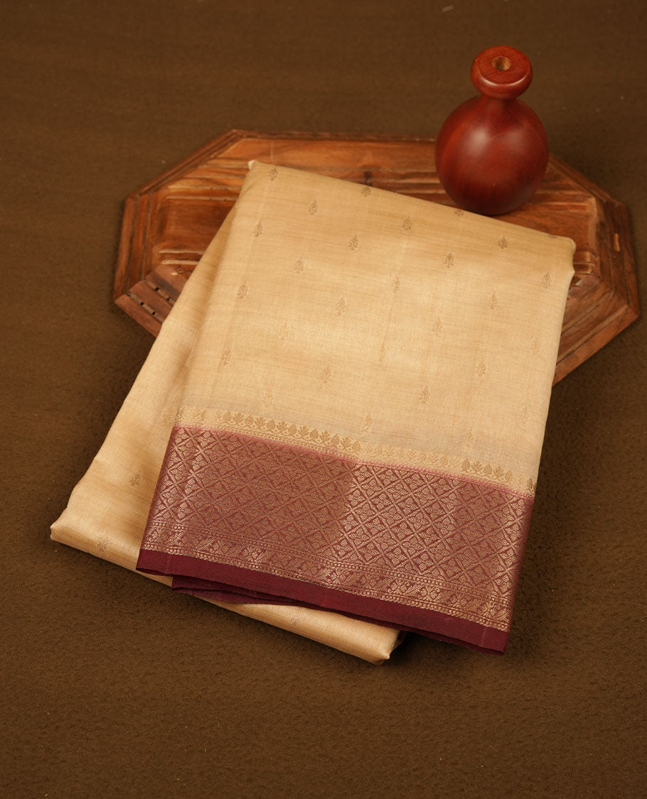 Light gold colour semi tussar saree featuring Gold zari buttas body, contrast chocolate brown colour gold zari border and comes with matching blouse piece.