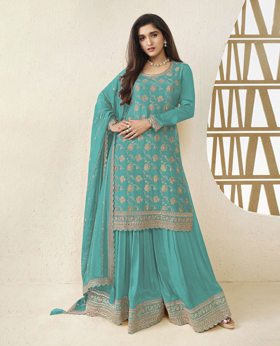 Aqua blue colour semi stitched salwar suit featuring an embroidered chinon top material paired with a matching sharara bottom, and dupatta.