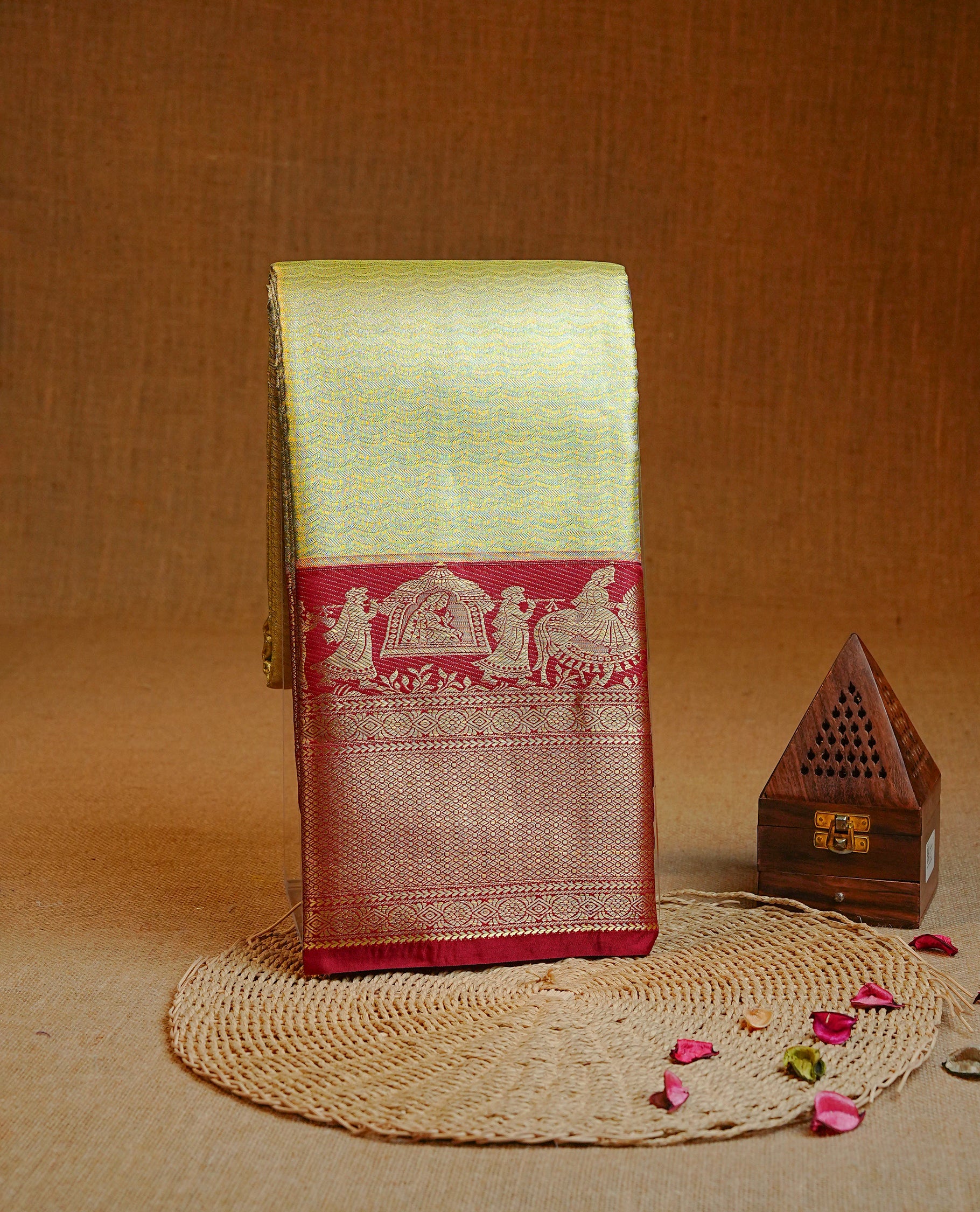 Gold colour Semi Tissue silk saree featuring silver zari pattern on body, complemented by traditional border with contrast Maroon colour, paired with matching blouse piece.