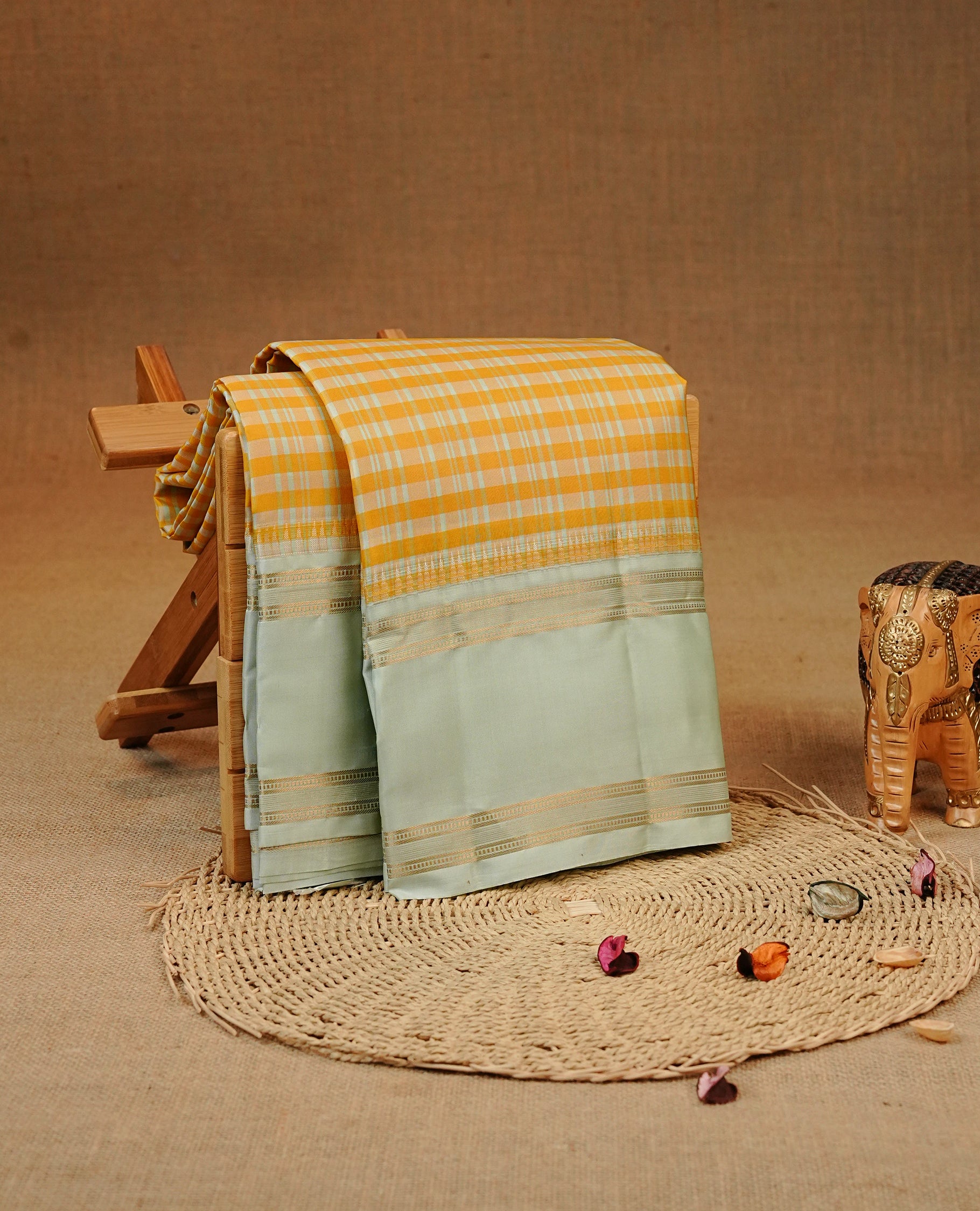 Yellow & ice Blue colour Kancheepuram silk saree featuring a check pattern on the body, complemented by Ice blue colour with Gold zari border, comes with matching blouse piece.