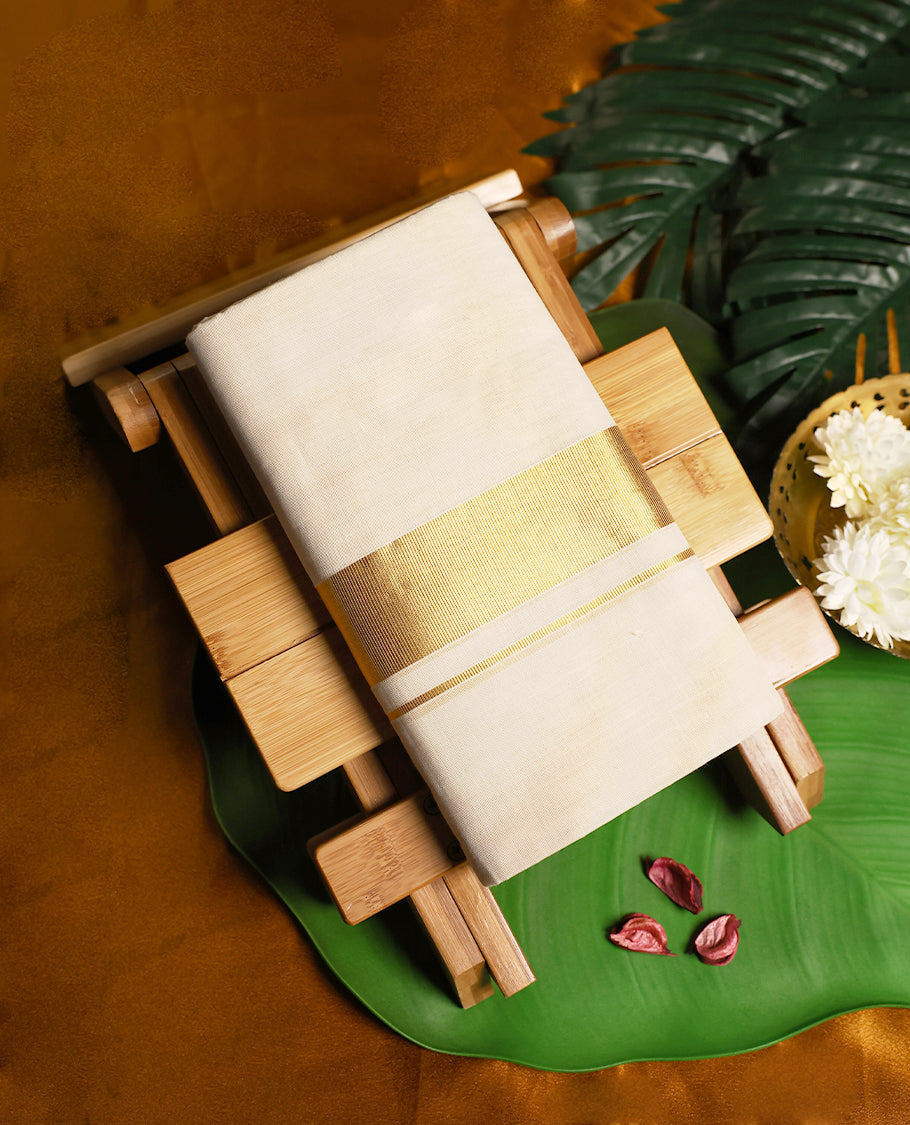 Elegant ivory white pure handloom cotton dhoti, featuring a rich golden zari border, crafted for traditional charm and everyday comfort.