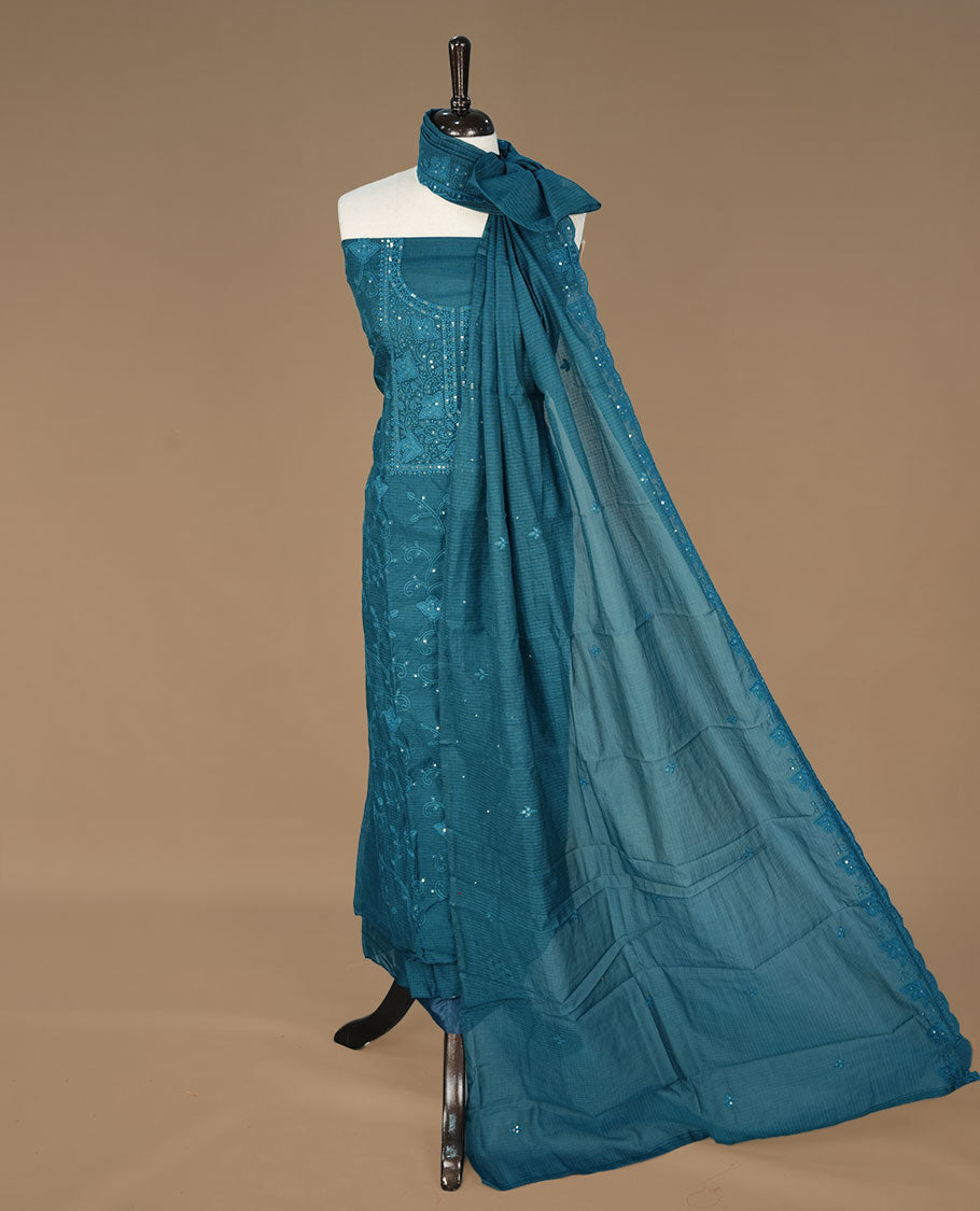 Teal colour churidhar material featuring self colour thread and sequins work on body, paired with matching bottom and Dupatta.