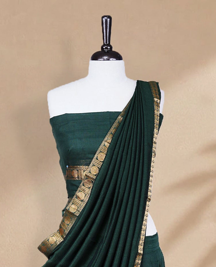 Bottle green colour Half saree featuring Plain skirt with Zari border on Self colour border, Unstitched Blouse and matching dupatta.