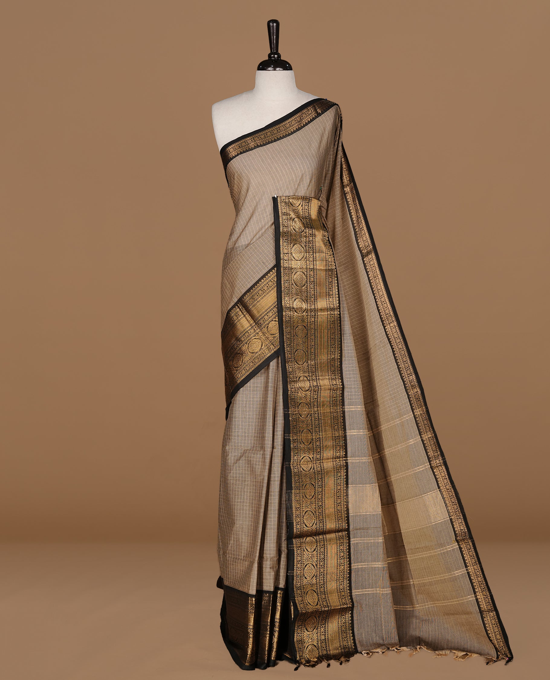 Grey Beige colour Chettinad cotton saree featuring Check pattern on body , complemented by contrast Black colour with zari border, comes with matching blouse piece.