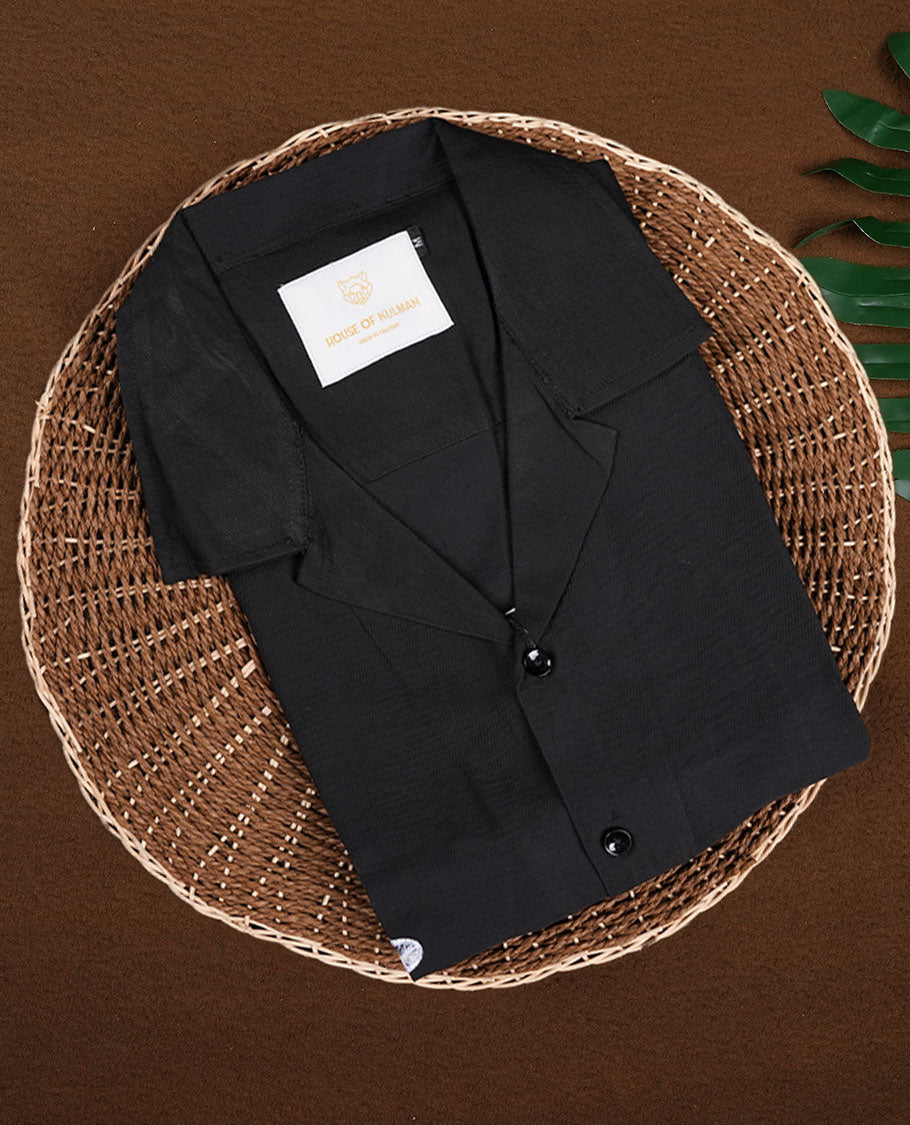 Black colour shirt featuring elegant white embroidery motifs on the body, Designed with a classic shirt collar and short sleeves, it blends contemporary style with subtle detailing.